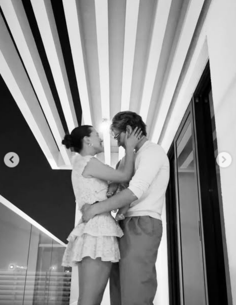 Millie Bobby Brown and Jon Bongiovi holding their daughter in an embrace, from a post dated December 3, 2025 | Source: Instagram/milliebobbybrown