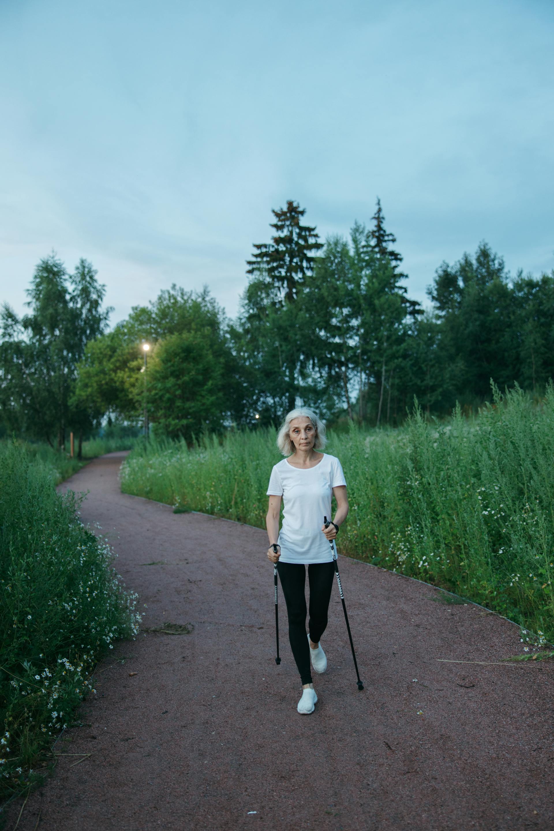 An old woman with walking sticks | Source: Pexels