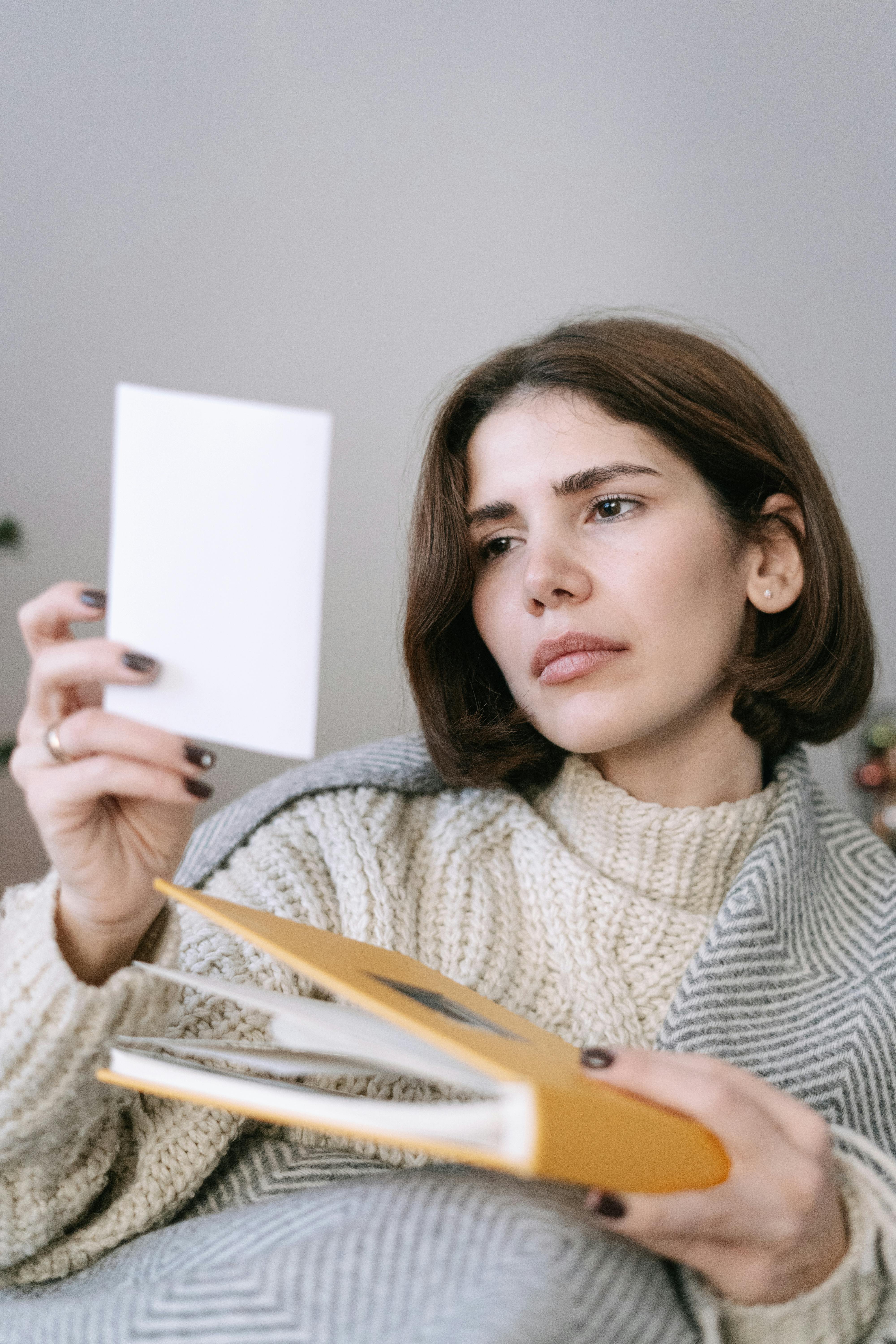 Woman looking at a photo | Source: Pexels