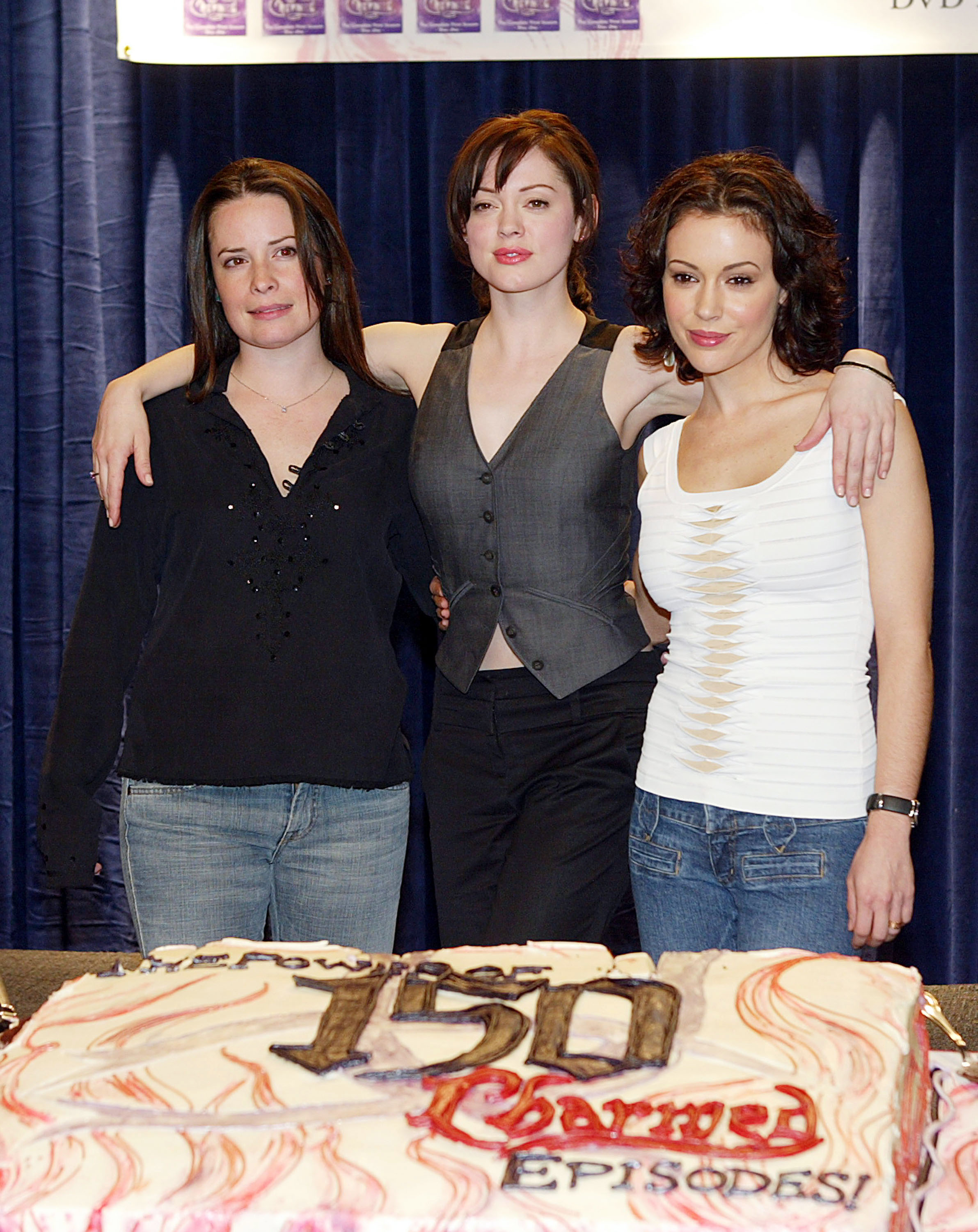 Holly Marie Combs, Rose McGowan, and Alyssa Milano celebrate the WB's "Charmed" 150th episode cake cutting on the set in Los Angeles, California, on February 1, 2005. | Source: Getty Images