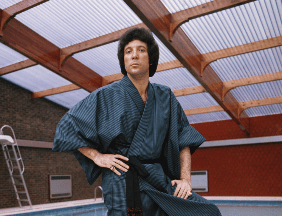 An undated image of Welsh singer and sex symbol Tom Jones standing by his swimming pool and wearing a robe at his home in St Georges Hill, near Weybridge | Photo: Getty Images