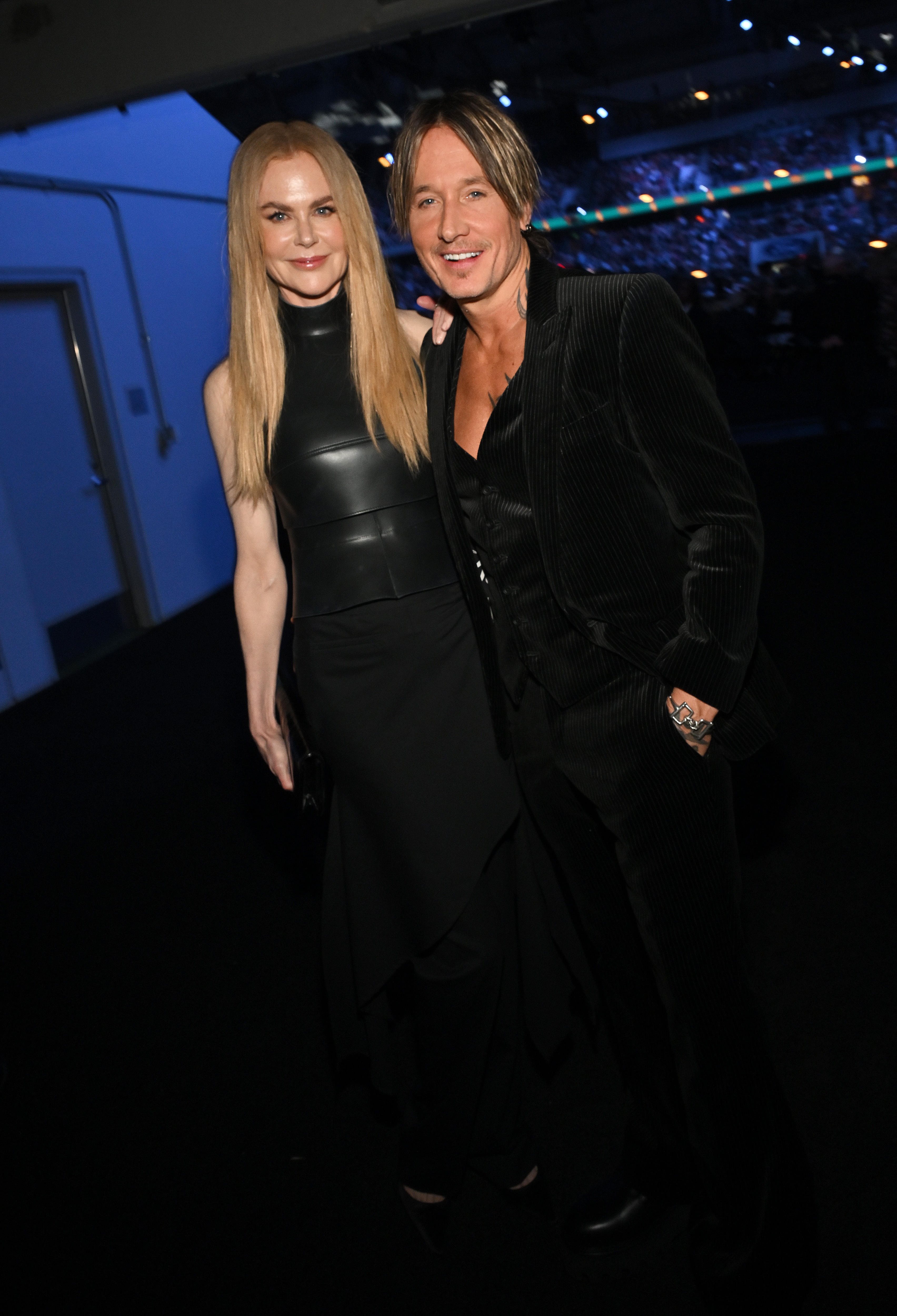 Nicole Kidman and Keith Urban appear at the 60th ACM Awards at the Ford Center in Frisco. Urban opts for velvet while Kidman stuns in a sleek black leather outfit as they smile for the camera.