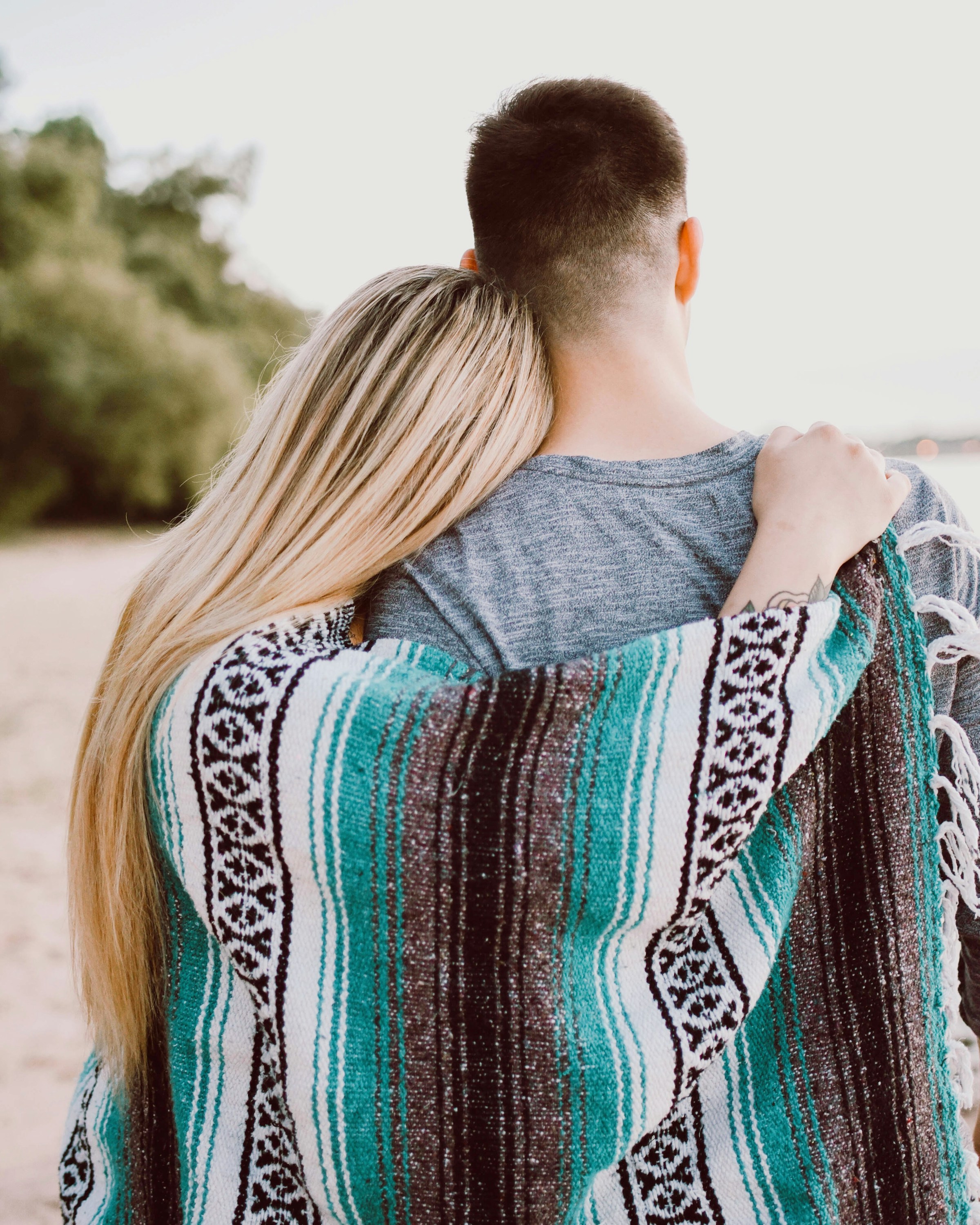 Rear view of a couple embracing each other | Source: Unsplash