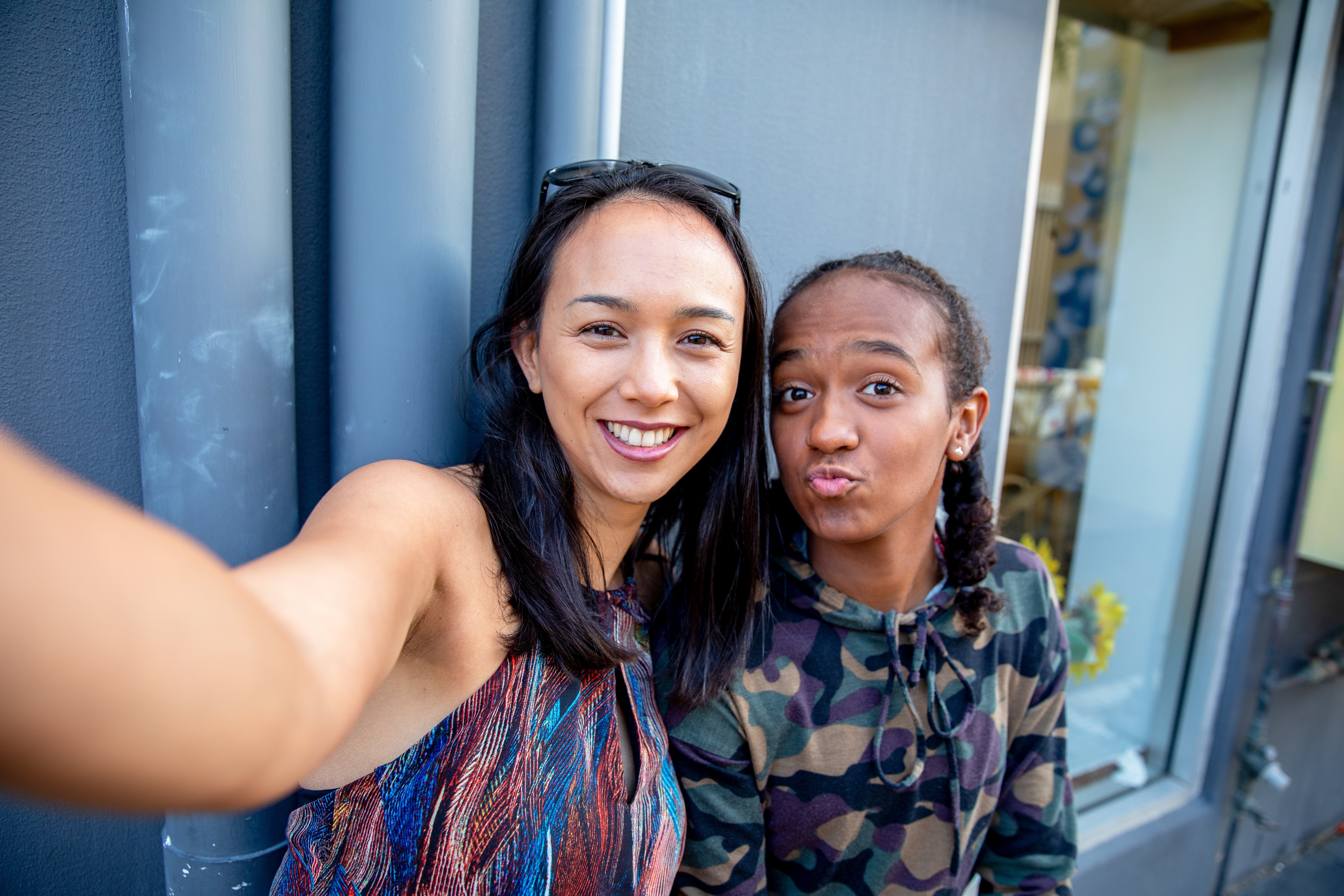 Aboriginal Australian Teenager walking through her city streets, with her mother, posing| Photo: Getty Images