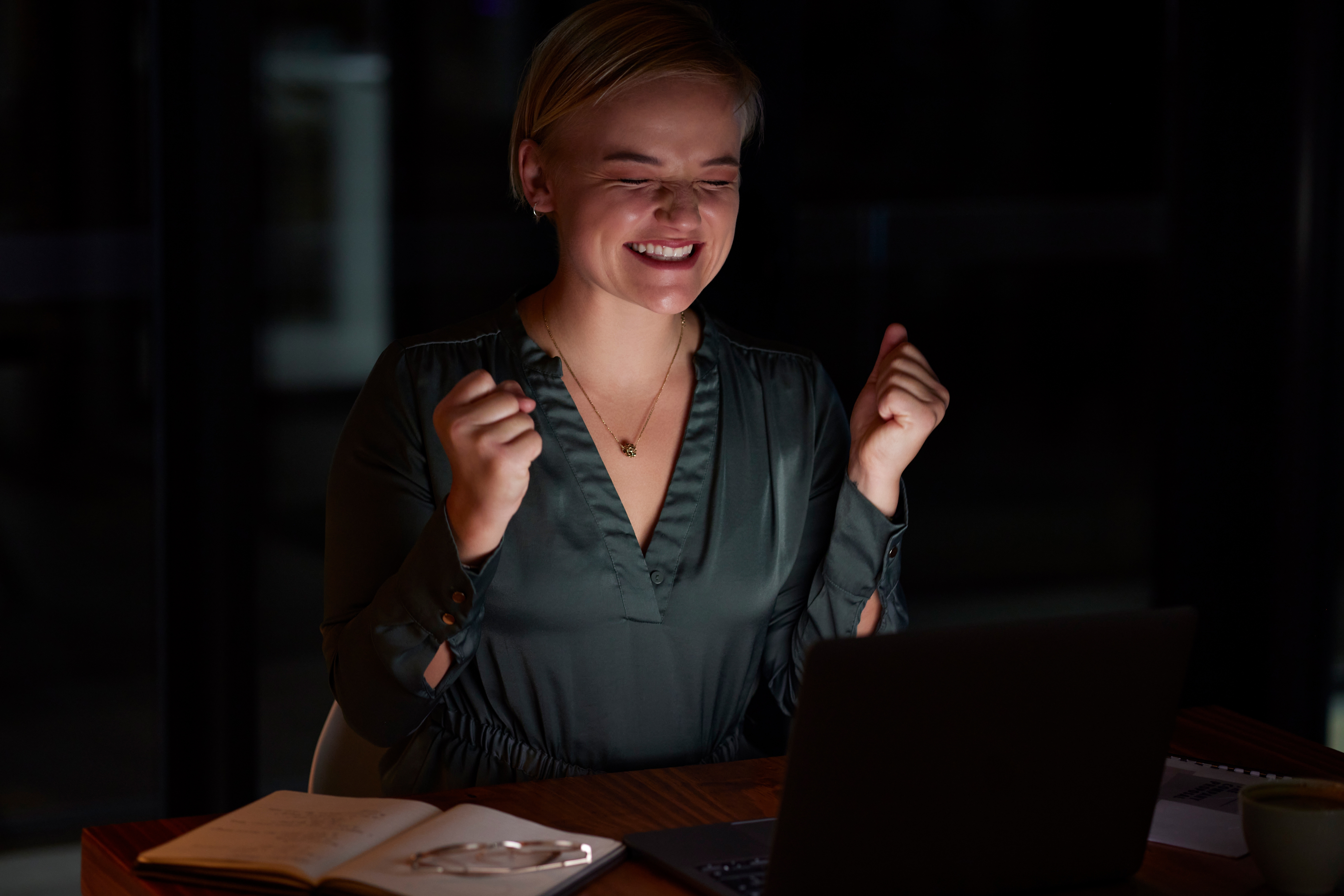 Night, laptop and woman with achievement. | Source: Shutterstock