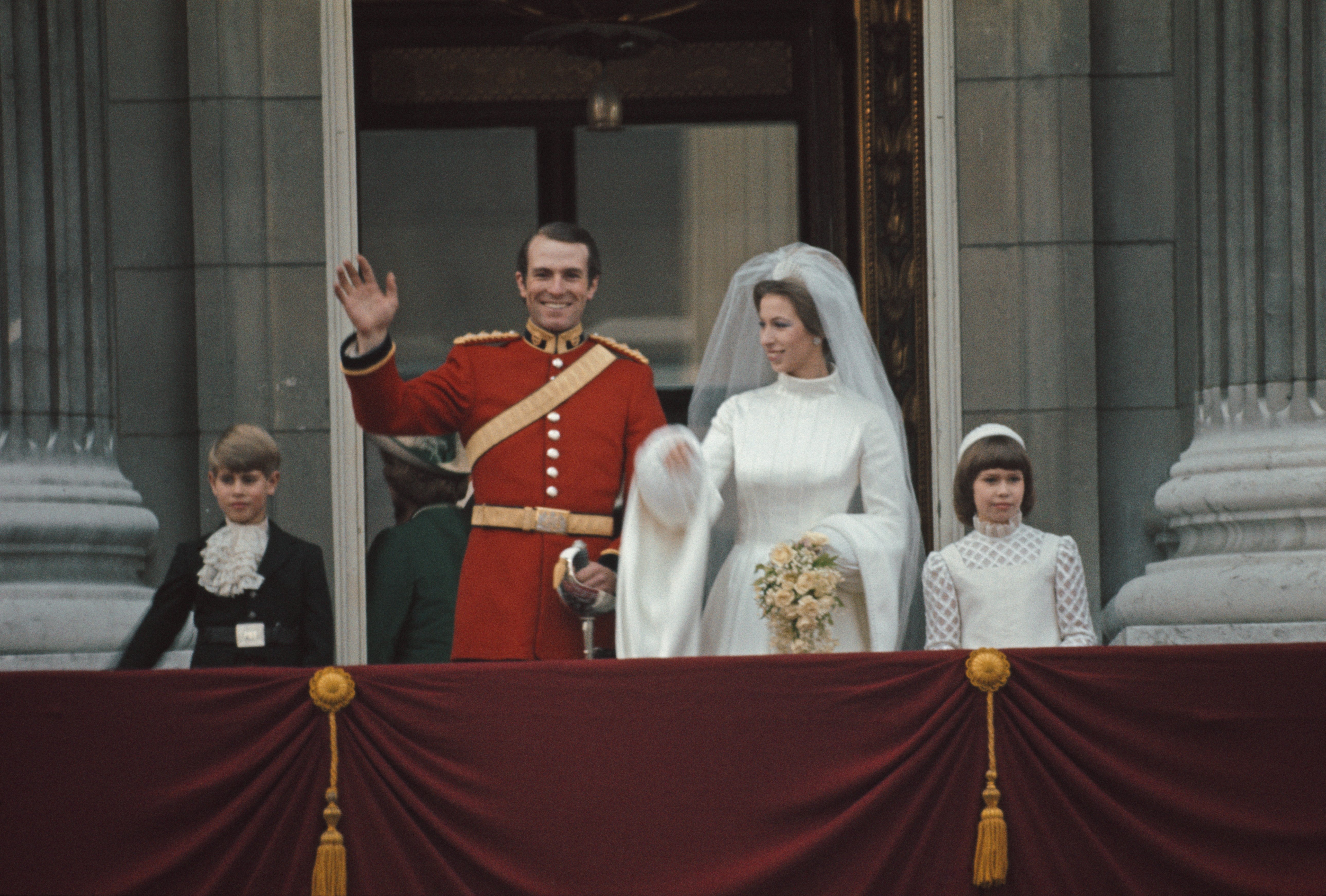 Princess Anne and Captain Mark Phillips wave from the balcony of Buckingham Palace following their wedding ceremony at Westminster Abbey on November 14, 1973 in London | Source: Getty Images