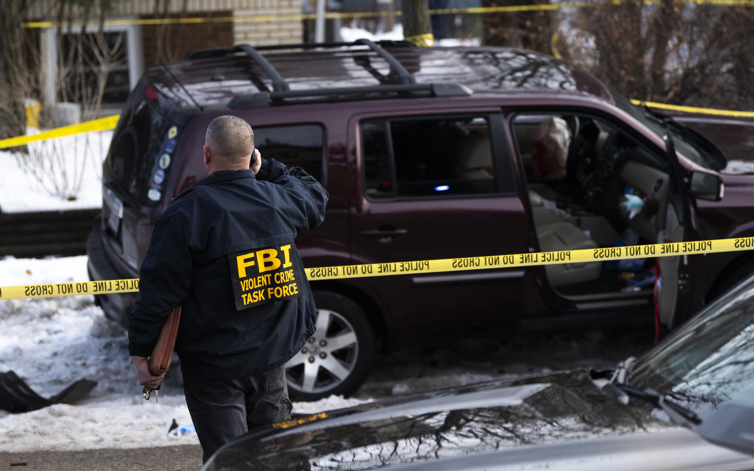 A federal agent investigates the vehicle involved in the deadly Minneapolis shooting | Source: Getty Images