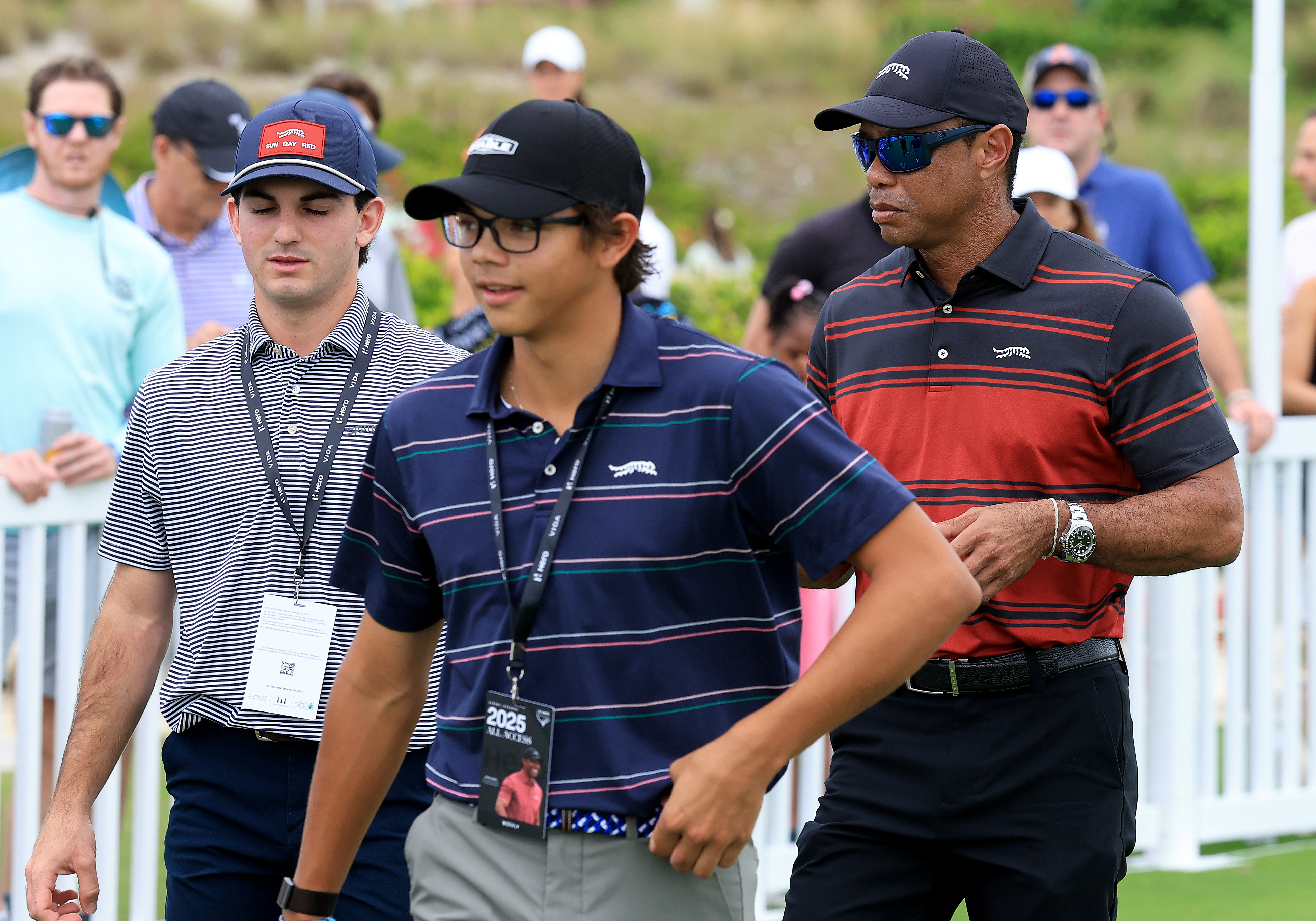 Tiger Woods walks behind Charlie at the Hero World Challenge in Nassau. The teen golfer looked locked in, with his father proudly following his every move.