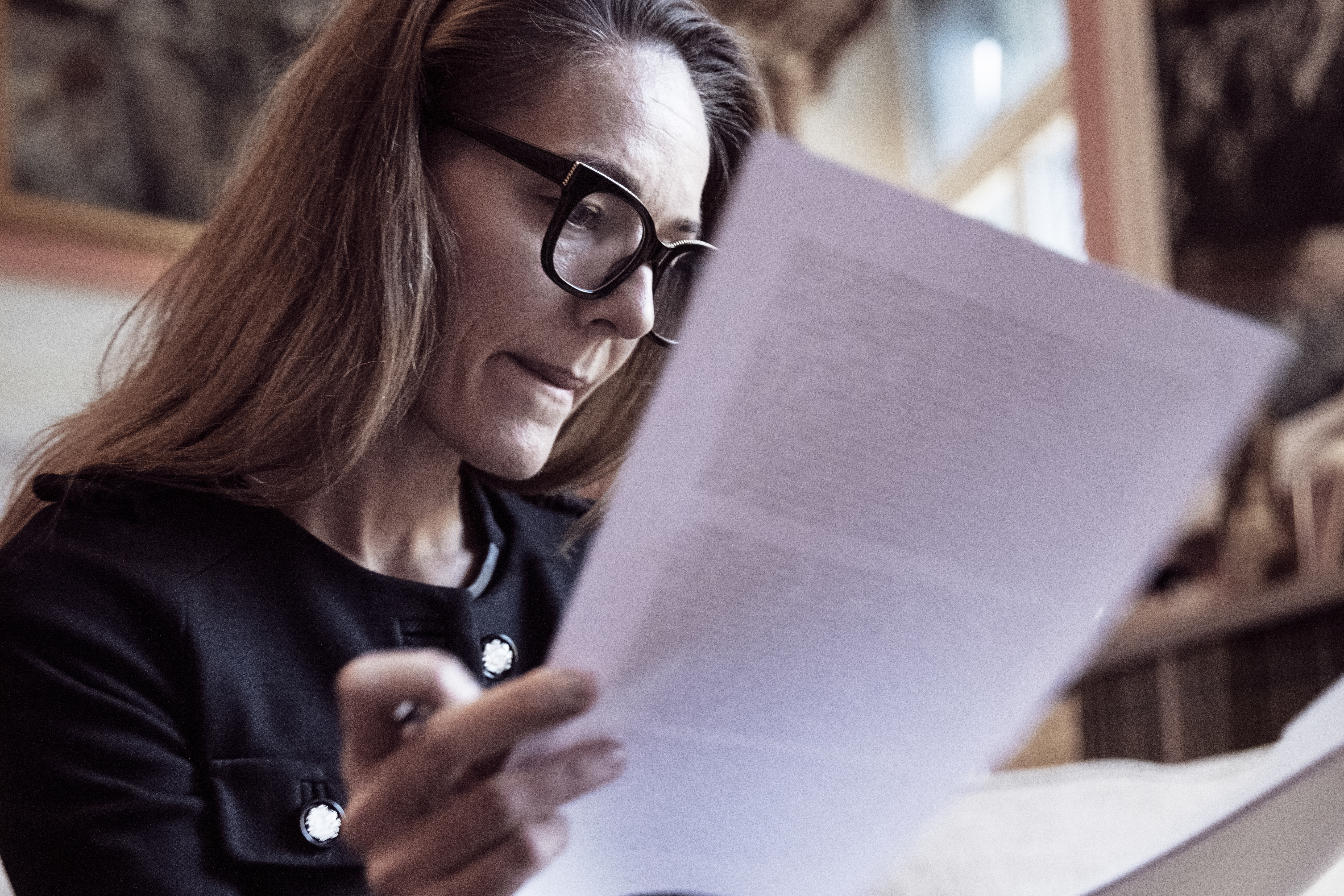 Low angle view of female professional analyzing documents at law firm | Source: Getty Images