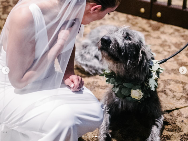 Winnie wearing a flower garland, sharing a special moment with Kylie Kelce on her wedding day, posted on March 14, 2024 | Source: Instagram/kykelce