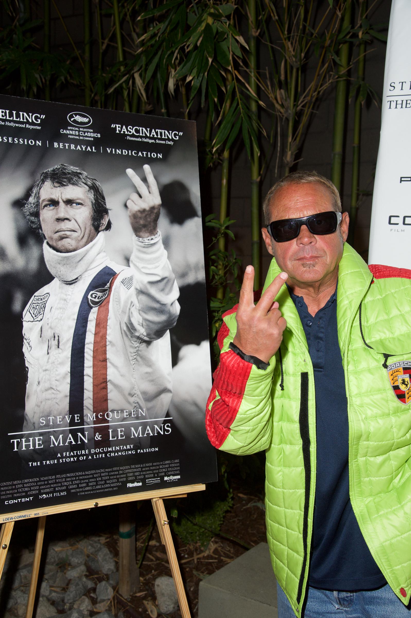 Chad McQueen poses next to his father's picture during the screening of FilmRise's "Steve McQueen: The Man And Le Mans" on November 11, 2015 | Source: Getty Images