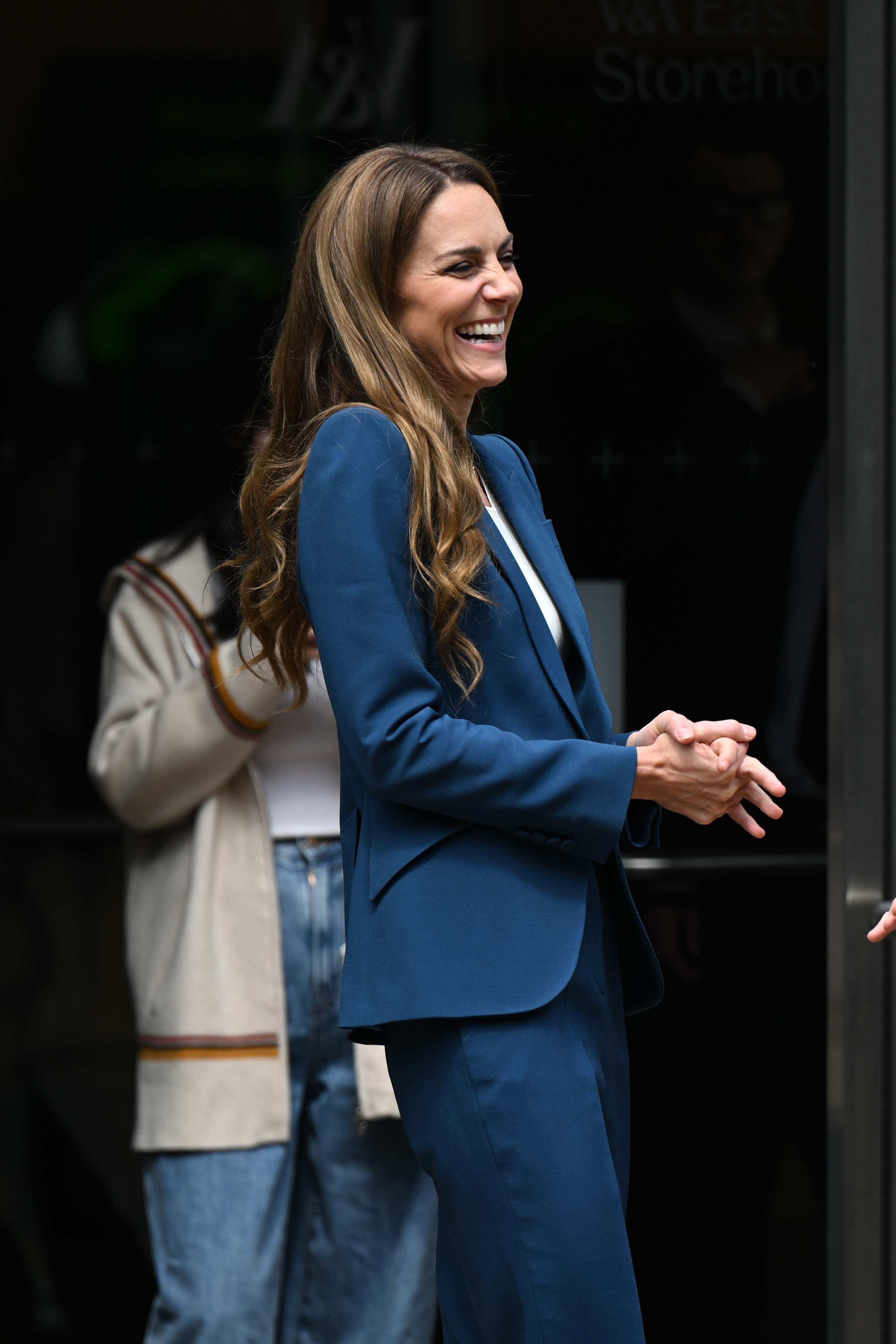 Laughing freely, Princess Catherine radiates charm and approachability. Her posture is relaxed, her suit crisp, and her natural expression captures a rare, candid burst of lightness at the museum on June 10, 2025.