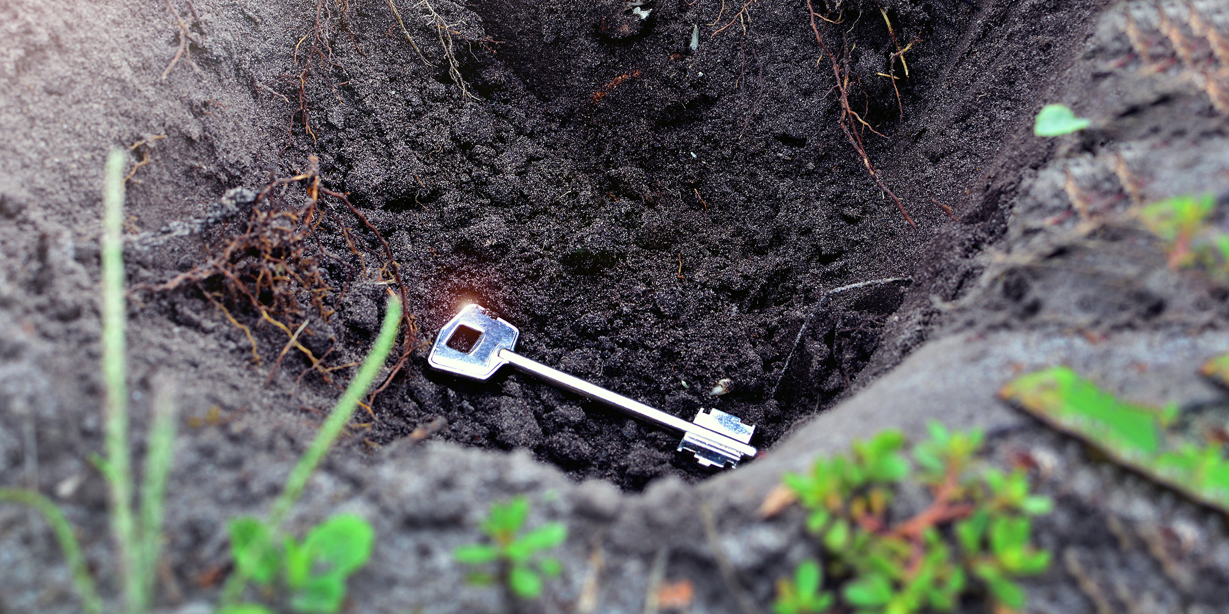 Key buried in soil | Source: Shutterstock
