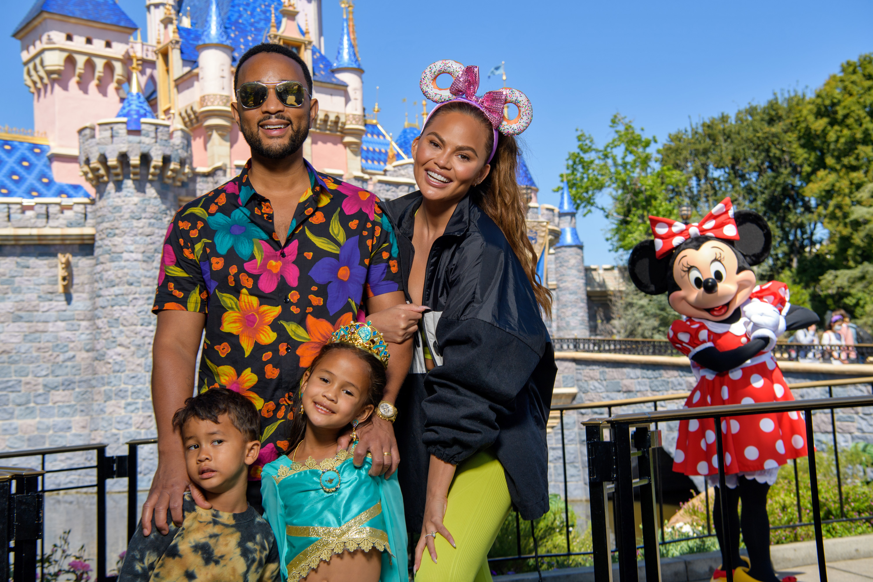 John Legend, Chrissy Teigen, and their children, Miles and Luna, with Minnie Mouse at Disneyland on April 14, 2022. | Source: Getty Images