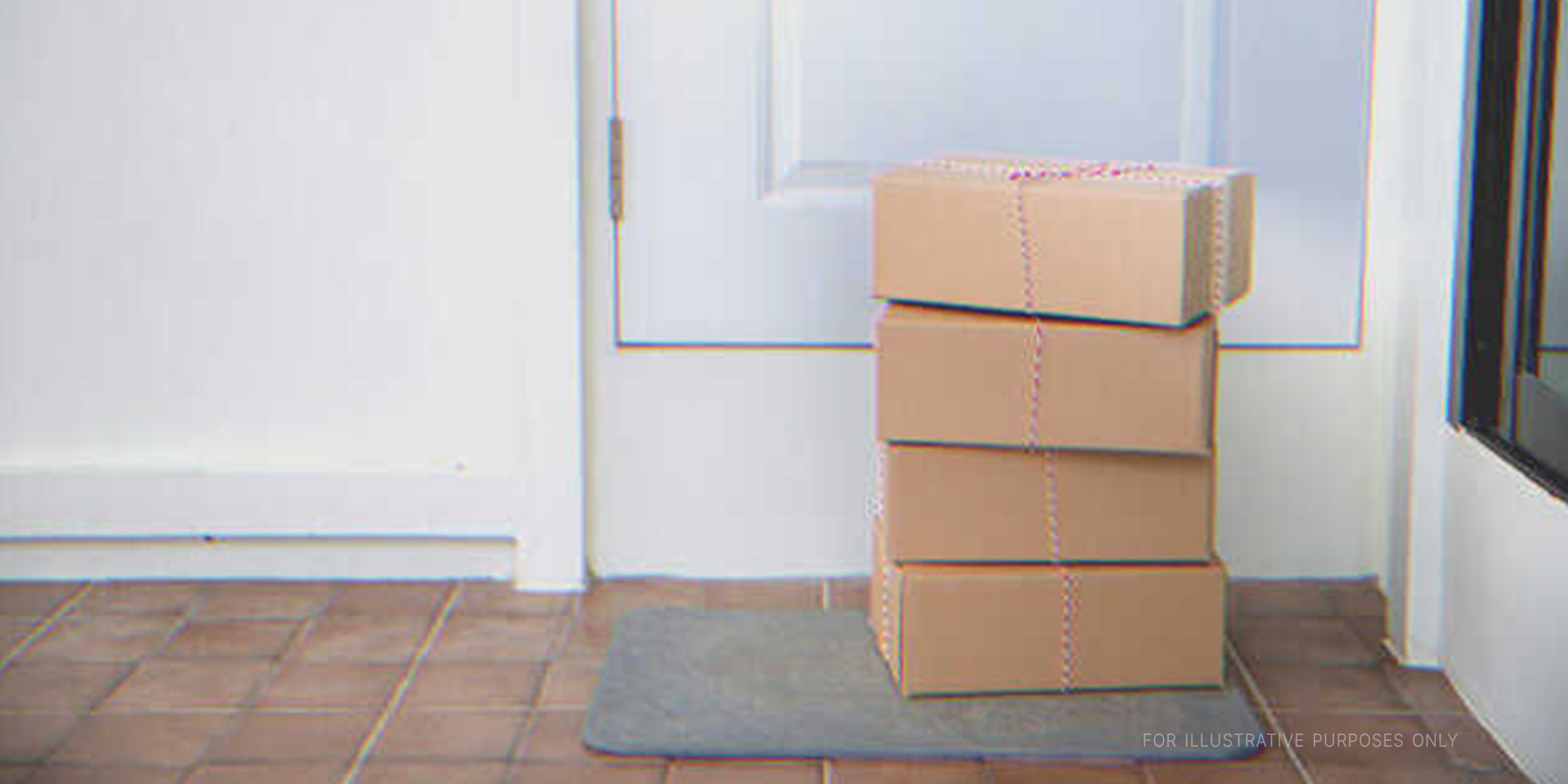 A stack of four boxes on a doorstep | Shutterstock