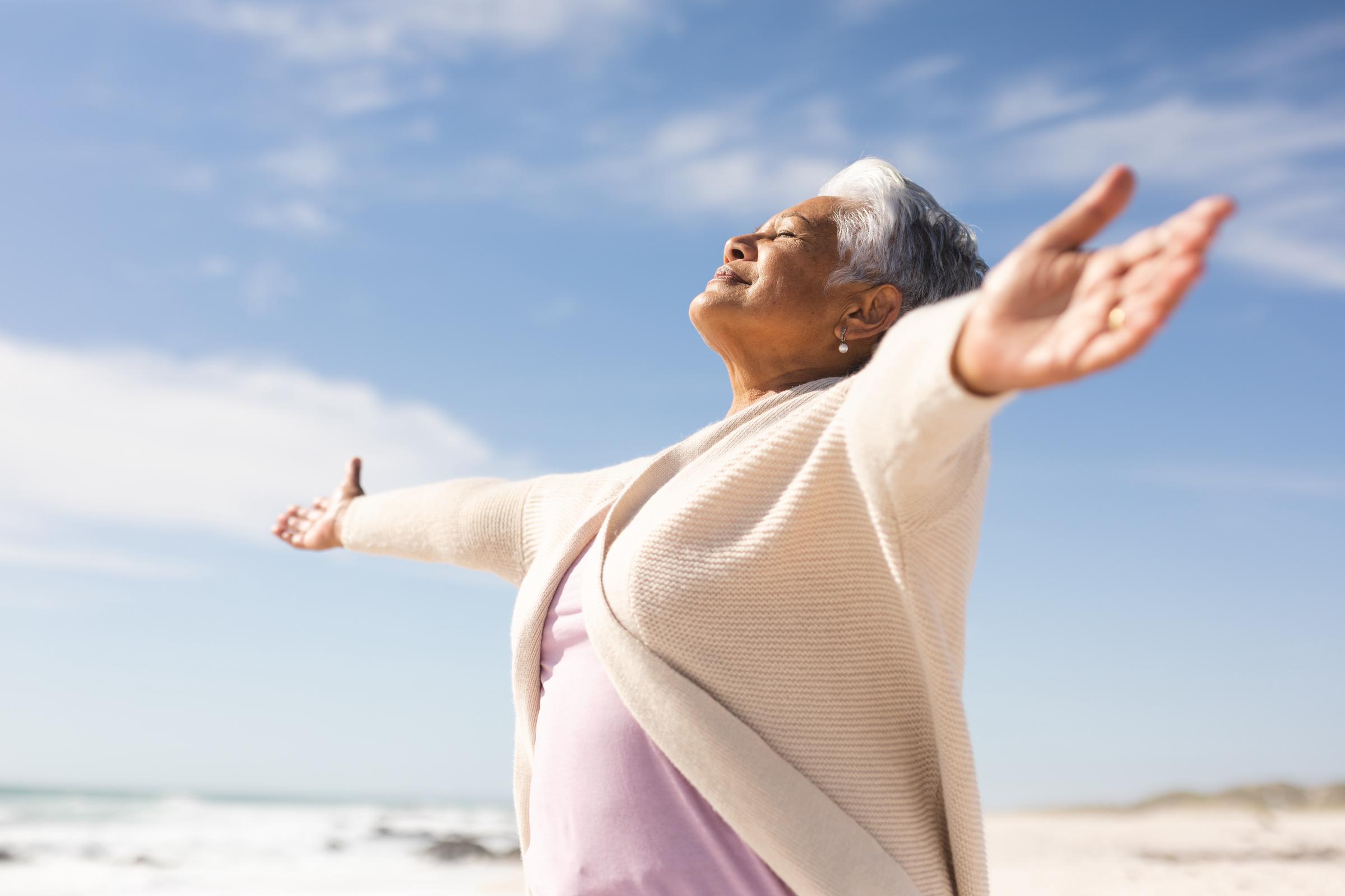Woman with outstretched arms outdoors | Source: Shutterstock