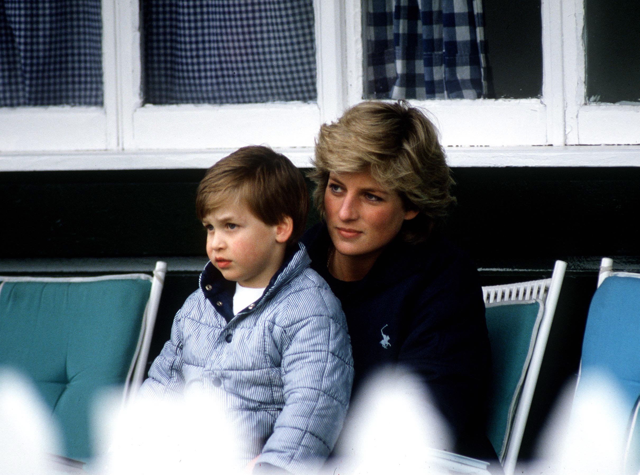 Princess of Wales, Diana with her eldest son Prince William sitting on her lap at Polo in Windsor, United Kingdom. / Source: Getty Images