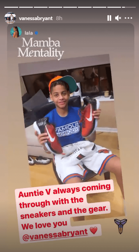 La La Anthony's son Kiyan holding up a pair of shoes gifted to him by Vanessa Bryant  | Source: Instagram/@vanessabryant
