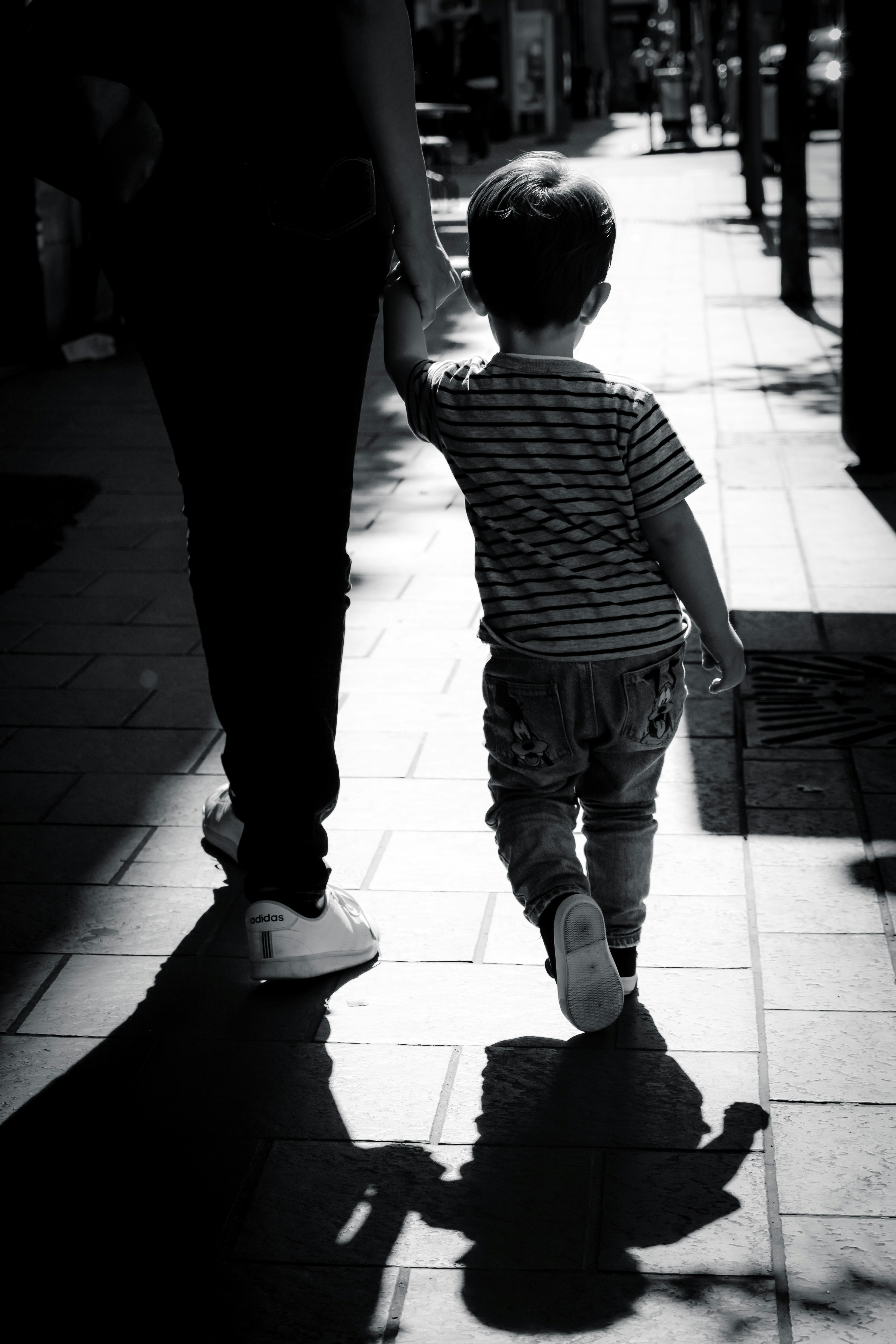 A woman walking with a boy | Source: Unsplash