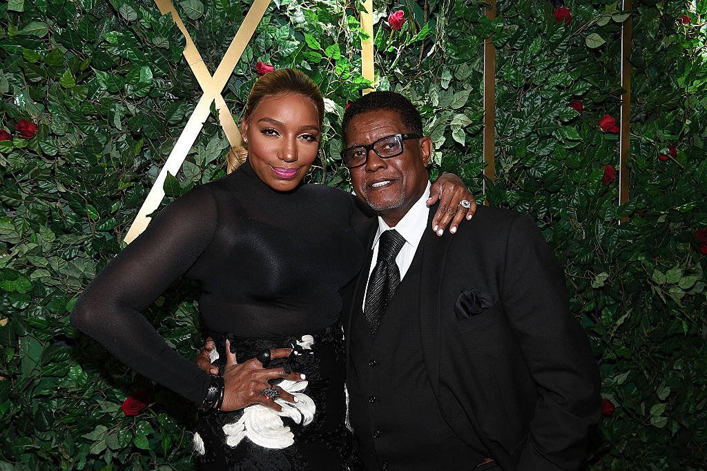 NeNe Leakes and Greg Leakes embrace in front of a rose and vine-covered wall during an appearance for Celebration For A Cure on January 13, 2017, in Atlanta, Georgia | Source: Paras Griffin/Getty Images
