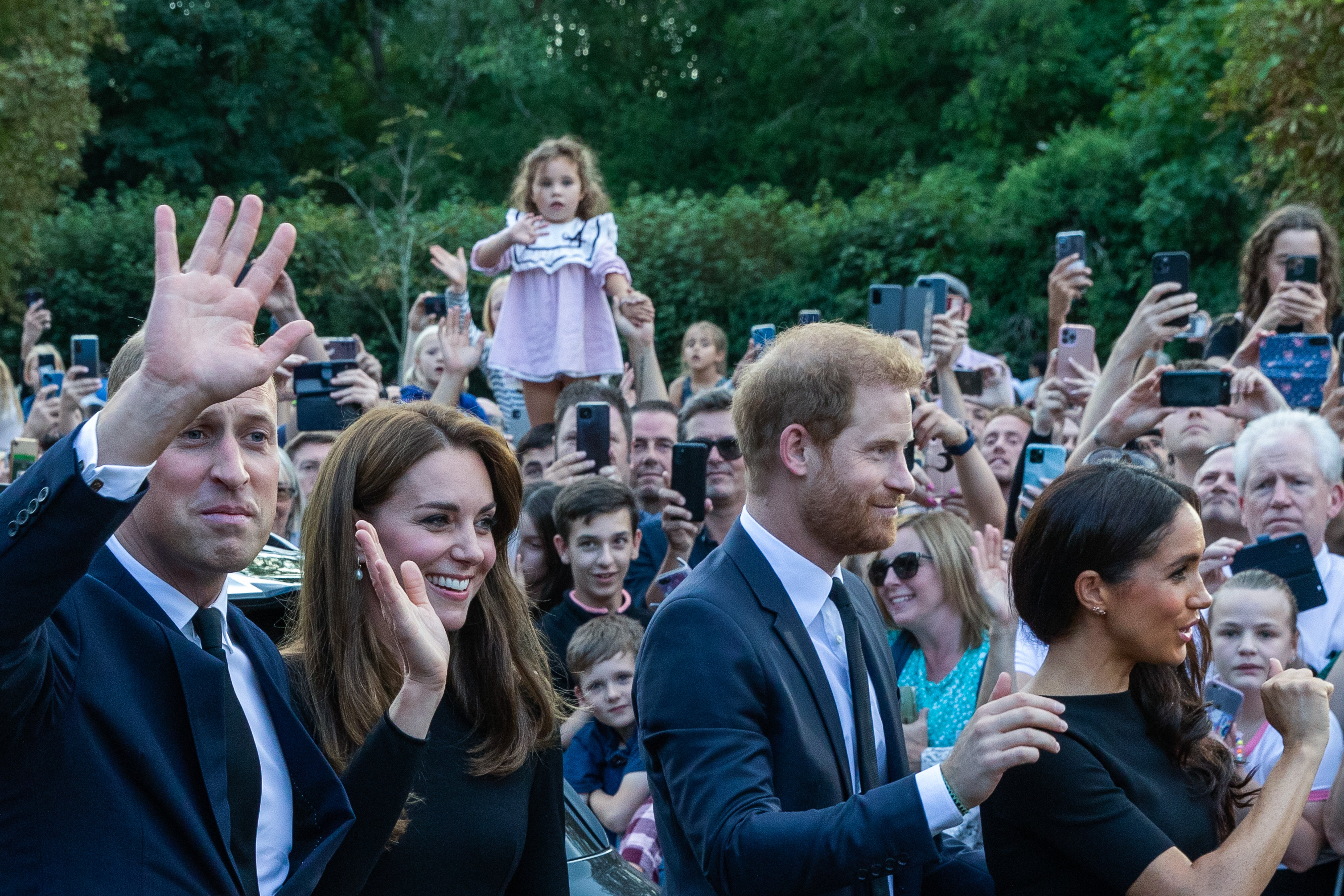 Prince William and Catherine, the new Prince and Princess of Wales, accompanied by Prince Harry and Meghan, the Duke and Duchess of Sussex, wave to well-wishers on the Long Walk outside Windsor Castle on 10th September 2022 in Windsor, United Kingdom | Source: Getty Images 