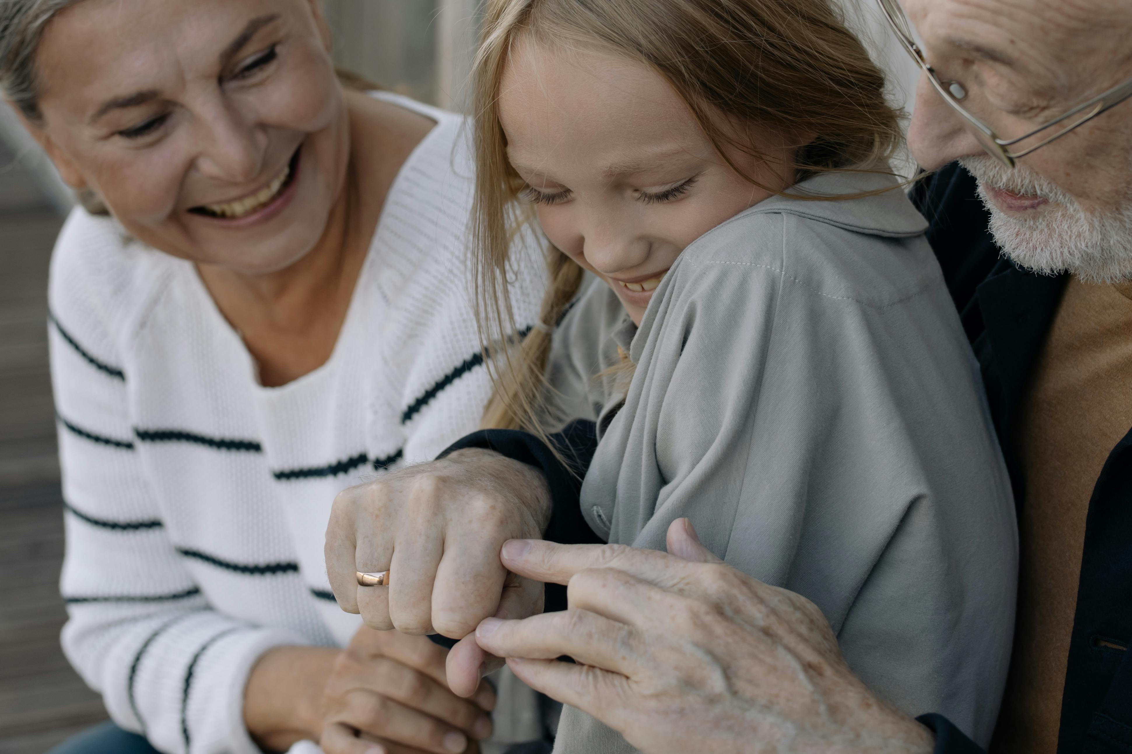 Granddaughter playing with her grandparents | Source: Pexels