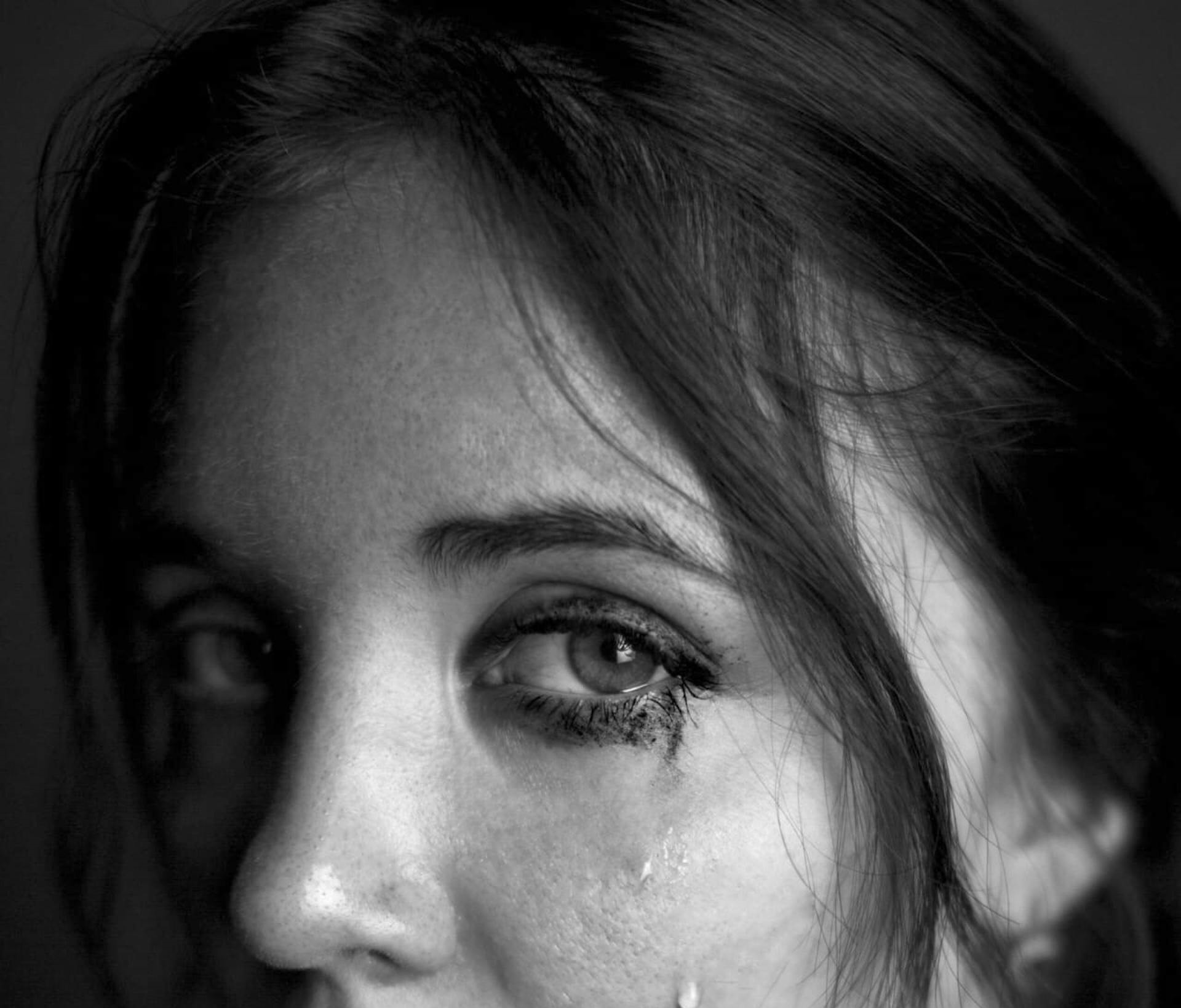 Grayscale close-up shot of a woman in tears | Source: Freepik