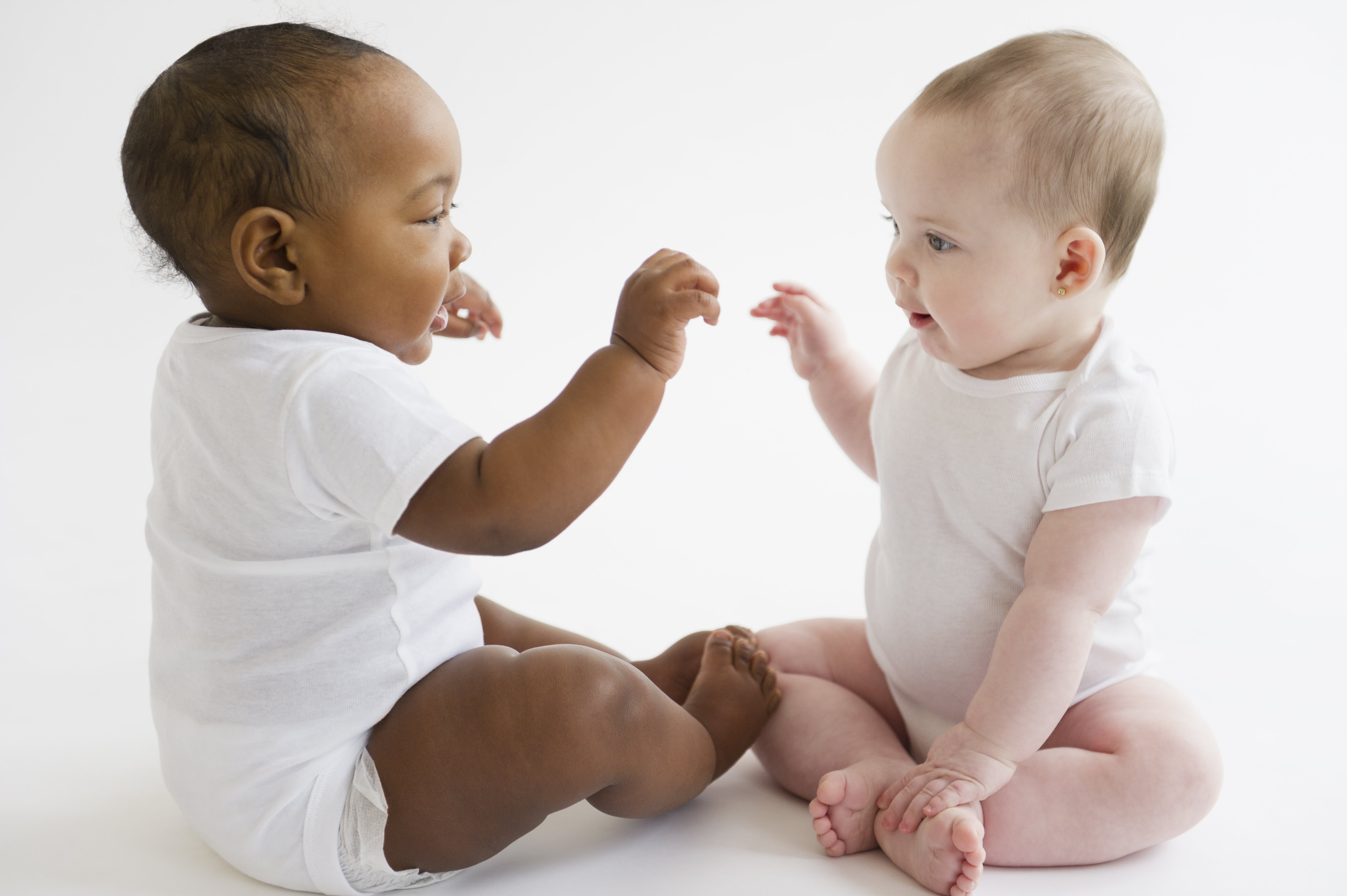 Two babies play together. | Source: Getty Images