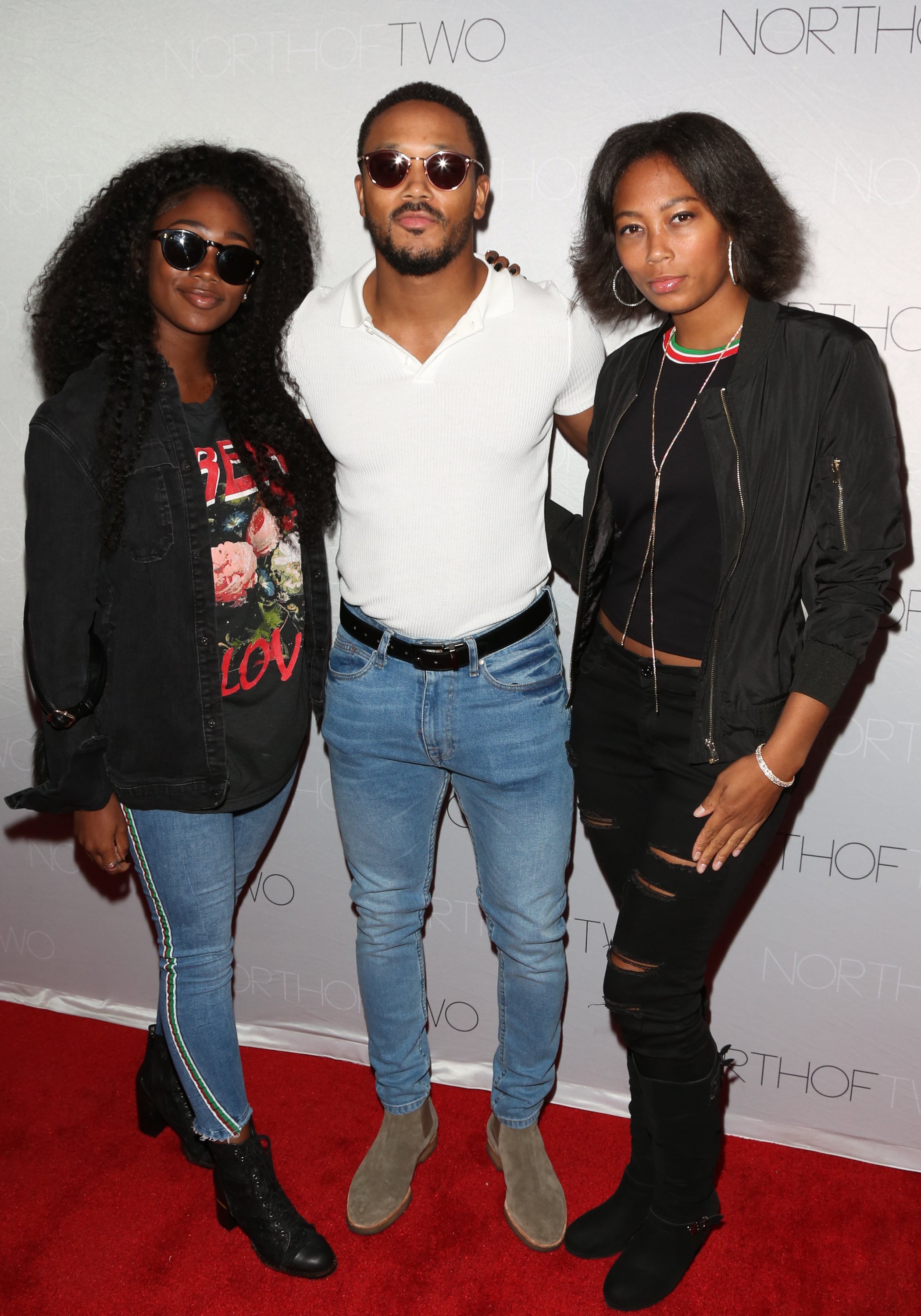 Actor Romeo Miller (C) with his sisters Itali Miller (L) and Inty Miller (R) at the premiere of "Adolescence" at Laemmle Monica Film Center on May 24, 2018, in Santa Monica, California. | Source: Getty Images 