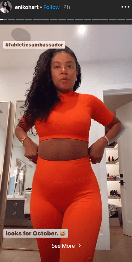 Eniko Hart posing for the camera in an orange outfit. | Photo: Instagram/Enikohart
