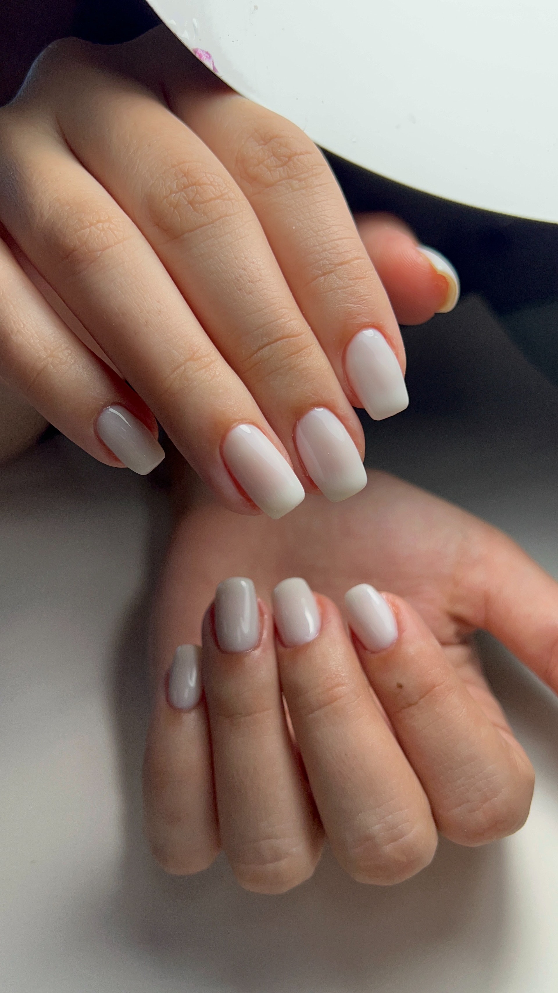 A woman wearing white nail polish | Source: Pexels
