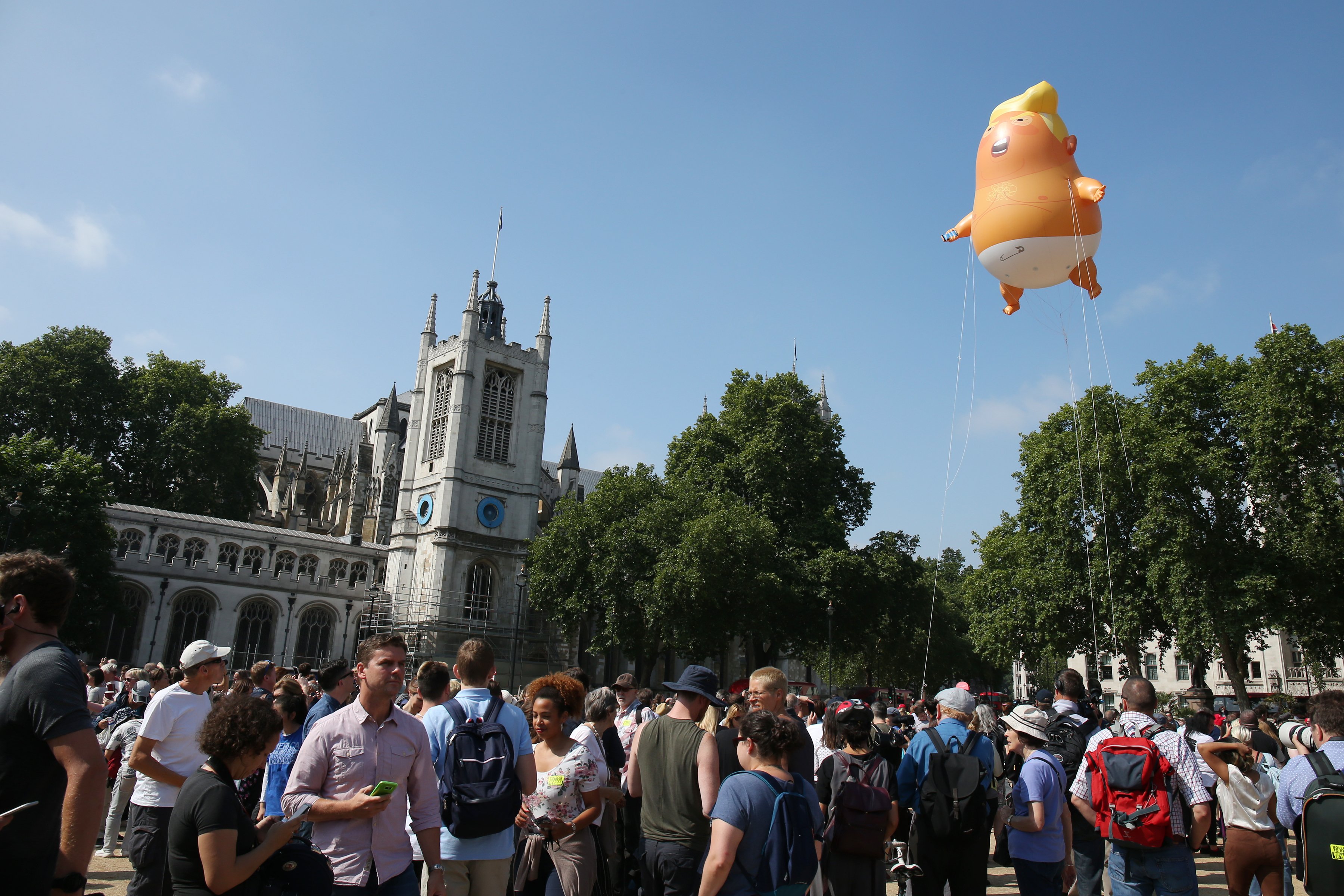 The Baby Trump blimp flying over Parliament Square in London, England | Photo: Getty Images