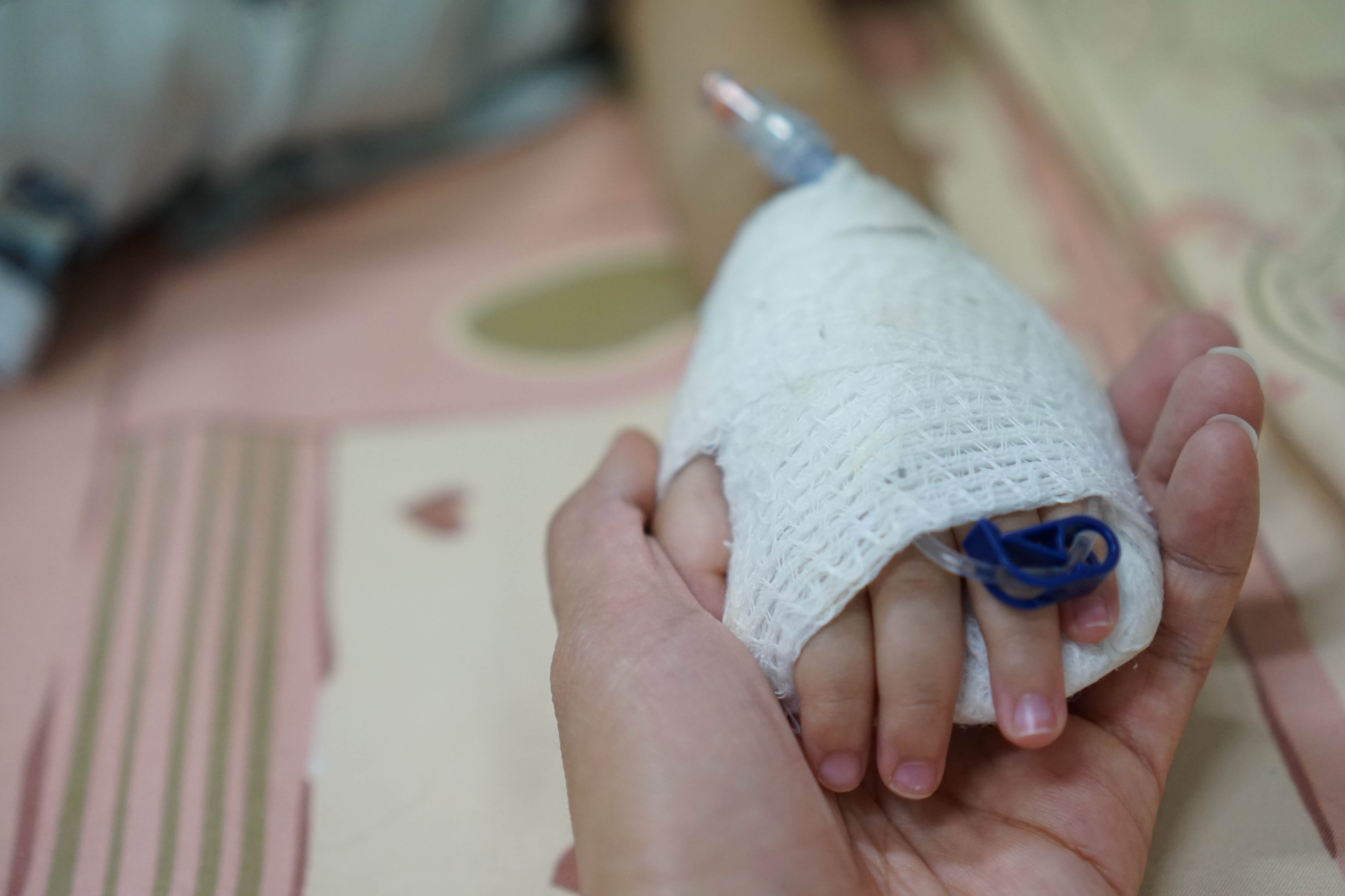 Mother is holding her child's hand in the hospital | Source: Shutterstock