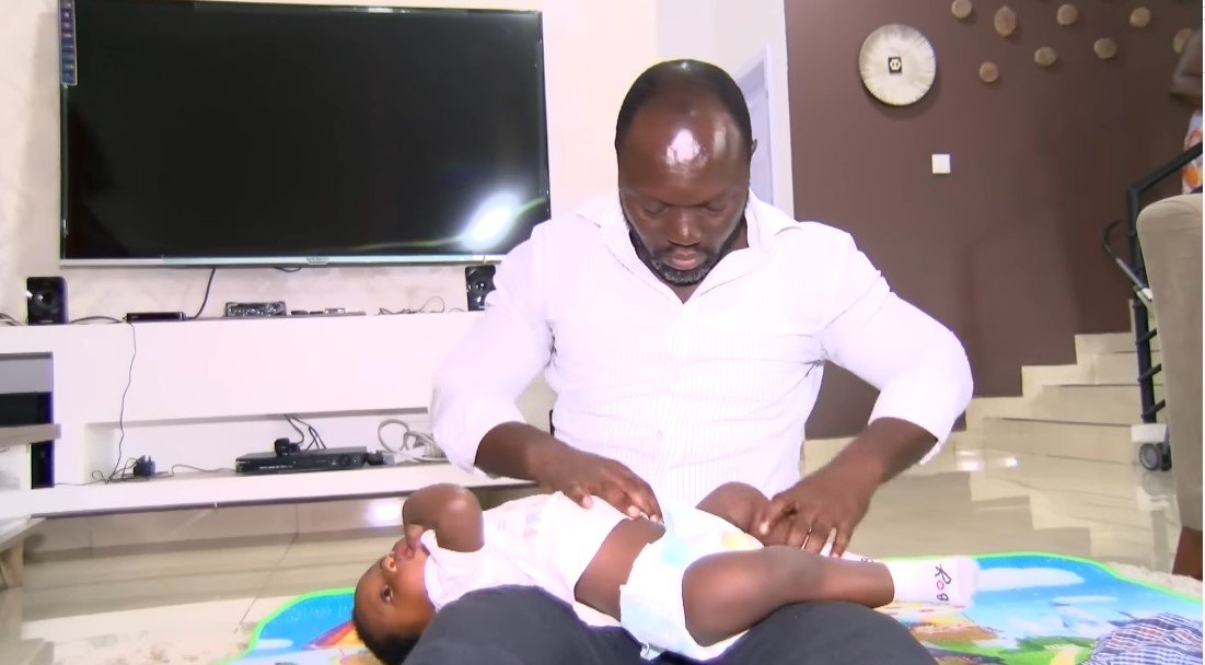 Edmund Akrofi with one of his twins | Source: Youtube/Joy Learning Tv