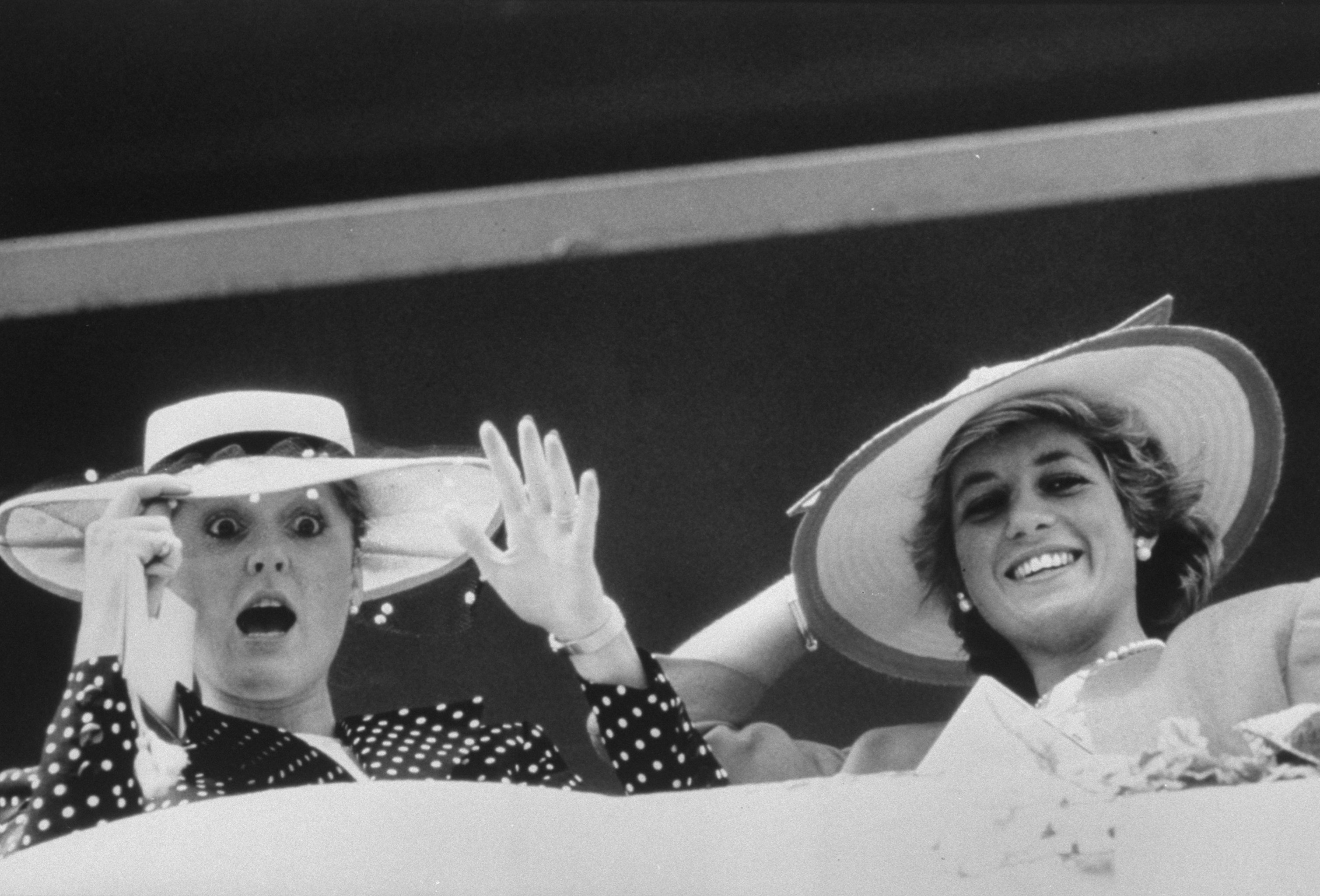 Princess Diana with her sister-in-law Sarah, Duchess of York, both wearing large hats at Epsom Downs. / Source: Getty Images