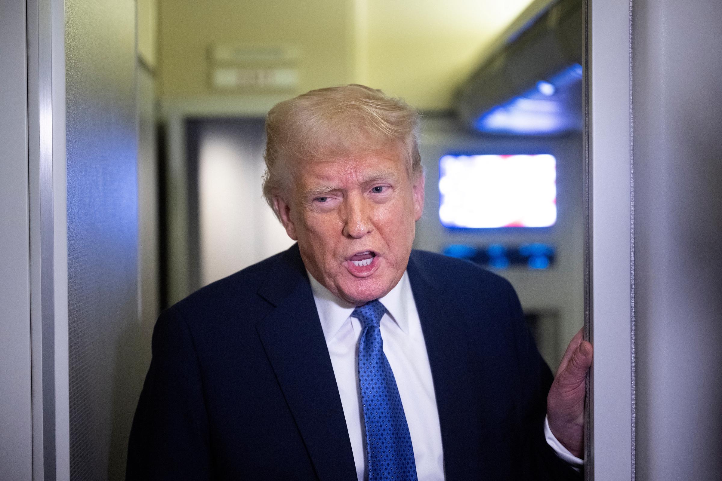 President Donald Trump speaks to reporters aboard Air Force One while flying to Washington, D.C., from Florida, on March 16, 2025 | Source: Getty Images