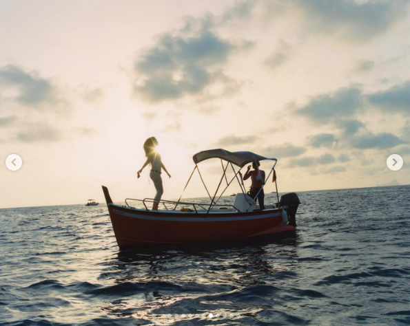 Katy Perry and an unidentified woman on a boat from behind-the-scenes snapshots of "Lifetimes," posted on August 10, 2024 | Source: Instagram/aidancullen1