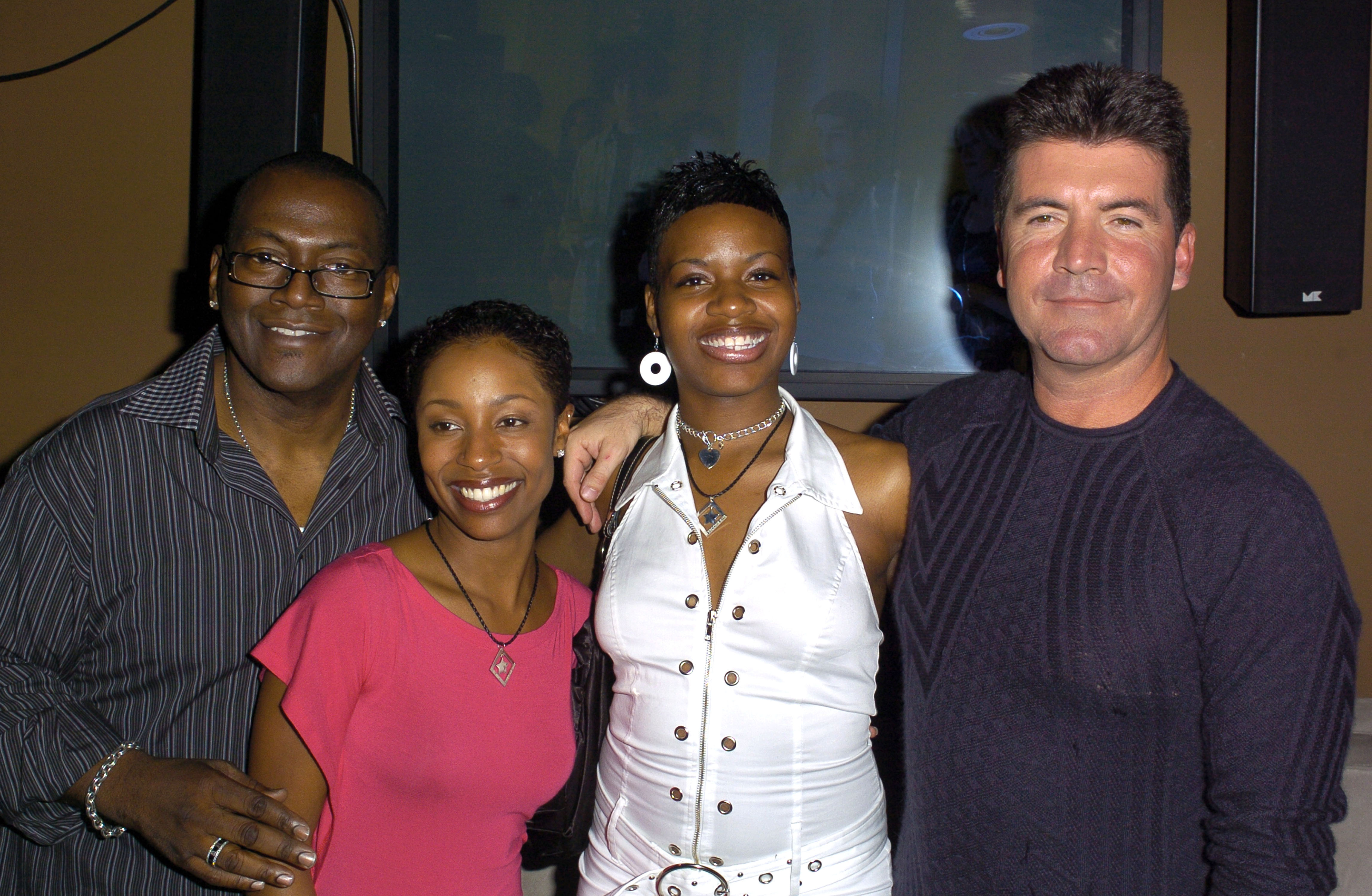 Randy Jackson flashes a relaxed smile beside LaToya London, Fantasia Barrino and Simon Cowell, as the group poses shoulder-to-shoulder at a lively “American Idol” finalists celebration.