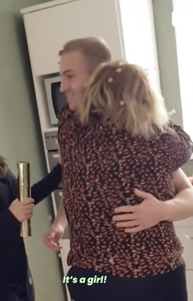 A man and his mother hugging at his child's gender reveal party | Source: tiktok.com/@itsgoneviral