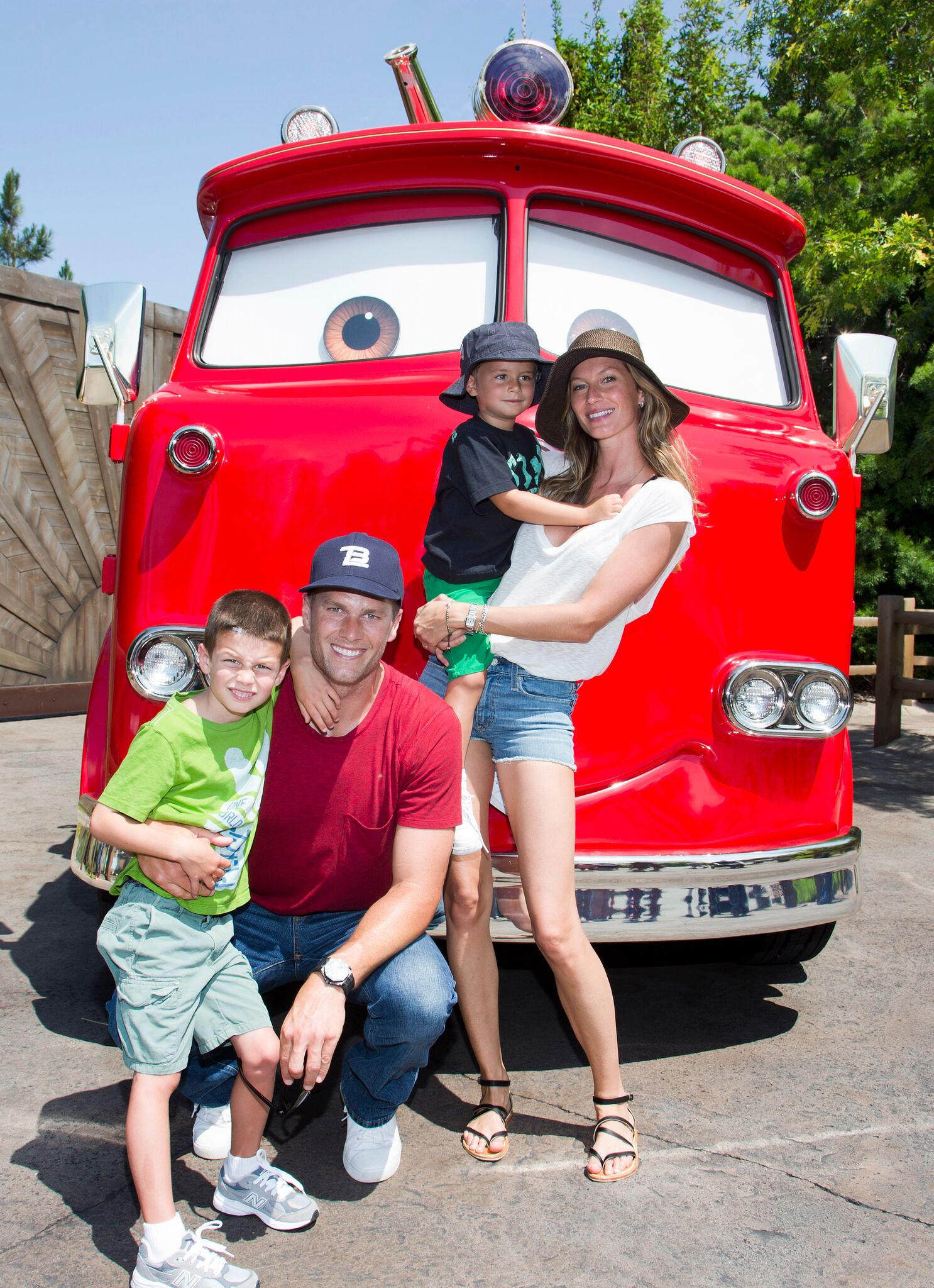  Tom Brady, his son Jack, 5, Gisele Bundchen, and their son Benjamin, 3, pose with Red the Fire Truck at Cars Land at Disney California Adventure park July 2, 2013  | Getty Images