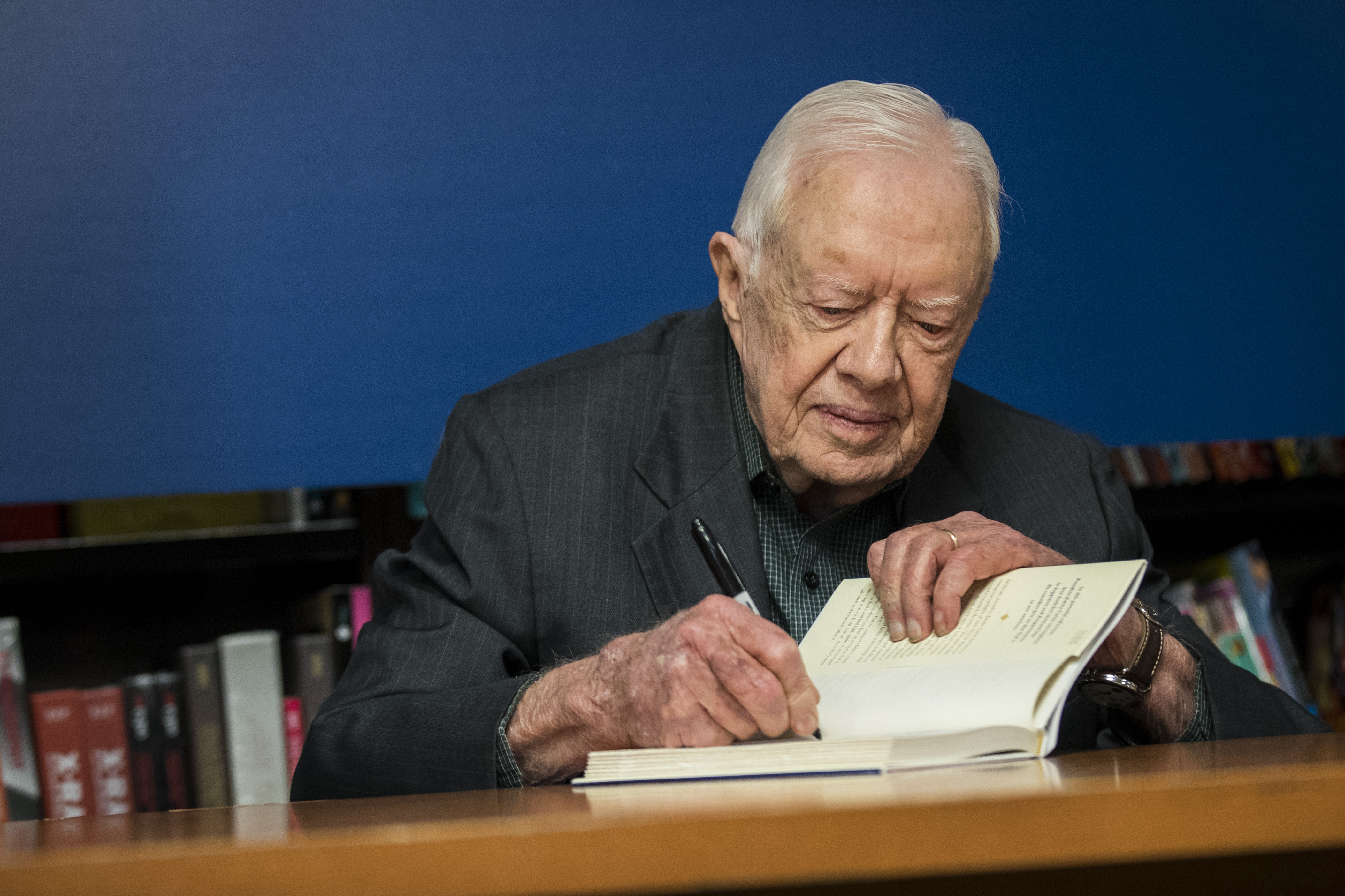 Jimmy Carter signs a copy of his new book “Faith: A Journey For All” at a book signing event at Barnes & Noble bookstore in Midtown Manhattan, New York City, on March 26, 2018. | Source: Getty Images