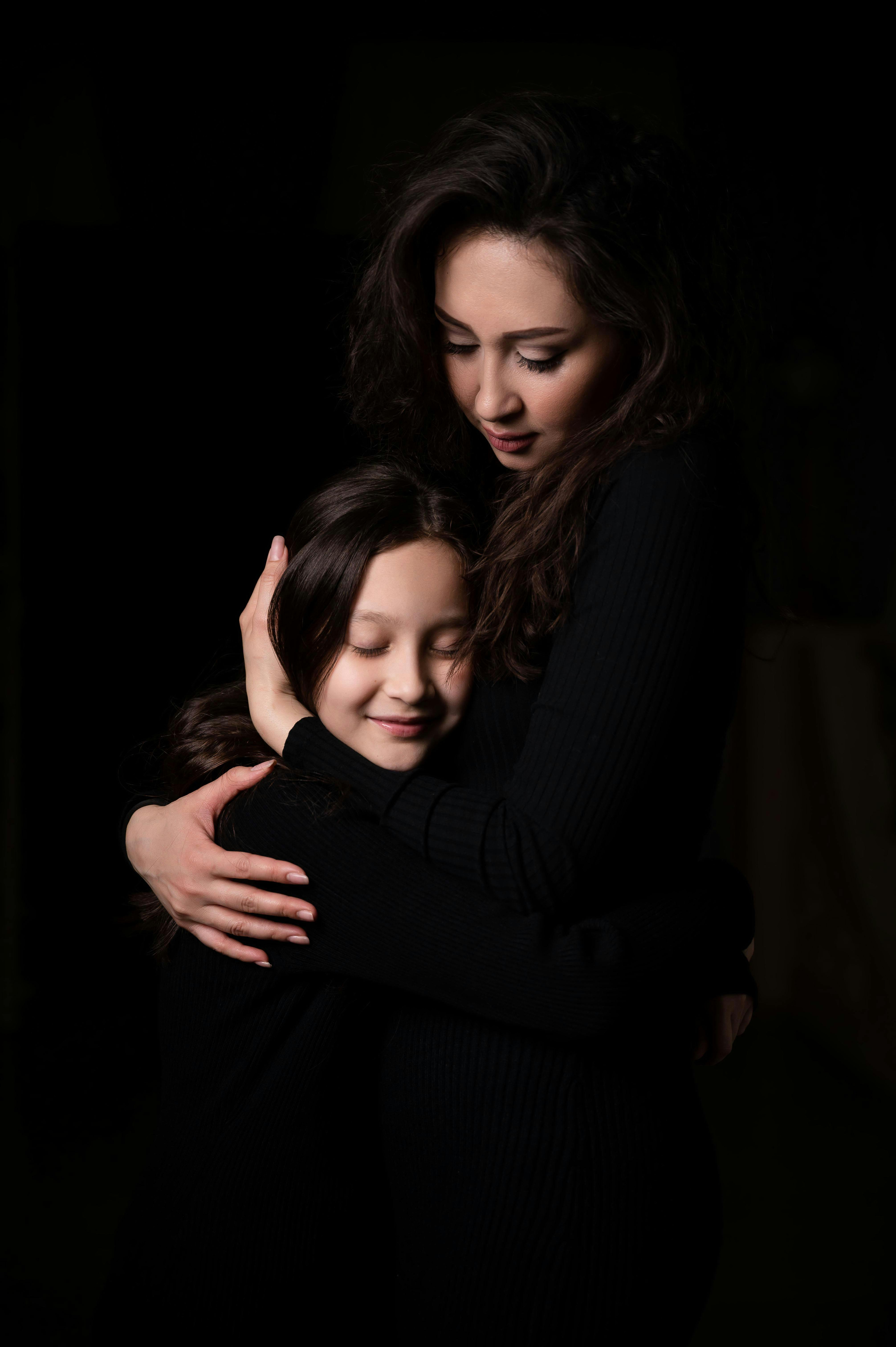 A proud woman embracing her daughter | Source: Pexels
