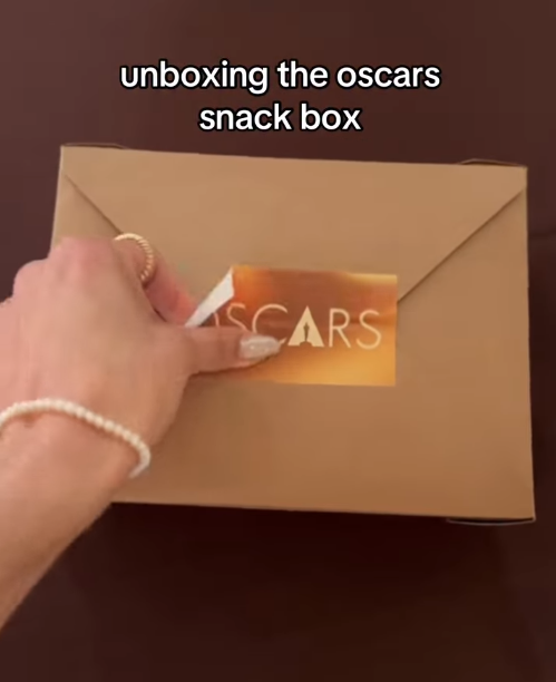 The seal is slowly peeled back, building anticipation as the official branding reveals what’s inside. | Source: Instagram/instylemagazine