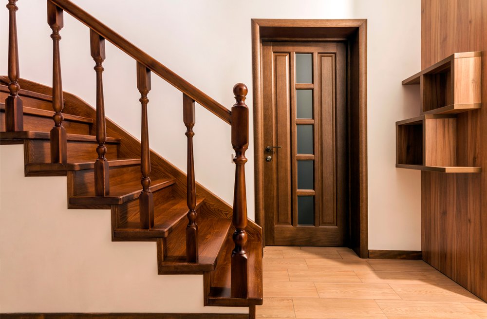 Modern brown oak wooden stairs and doors in new renovated house interior | Photo: Shutterstock