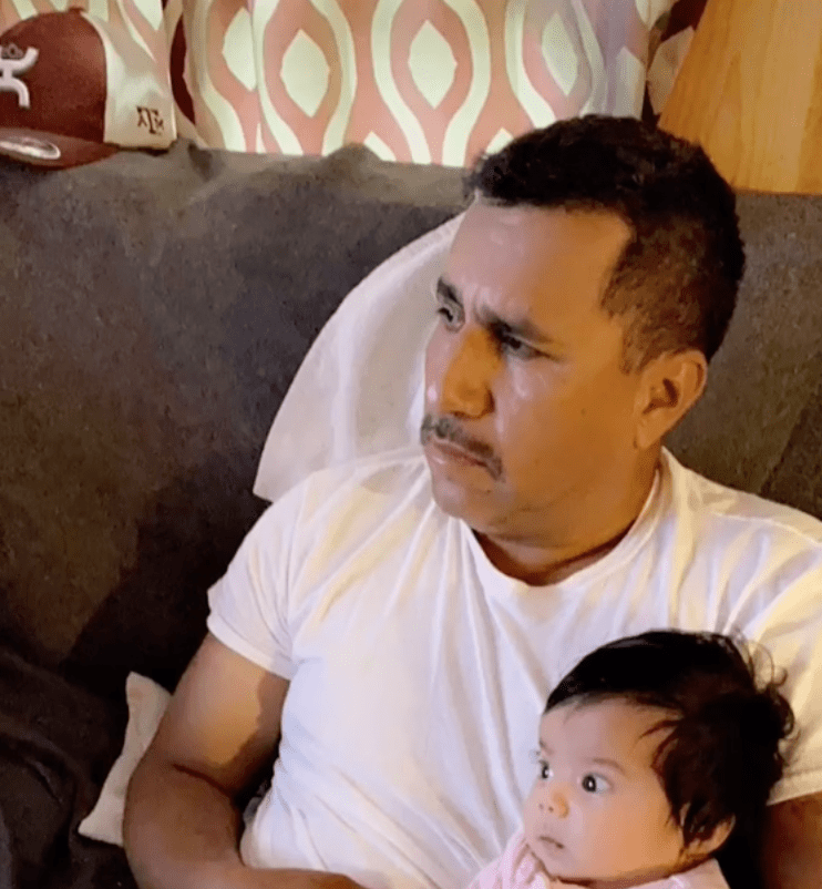In a viral TikTok clip a mother pans camera to show her father as he cuddles his new grandchild | Photo: TikTok/vanessaguilars
