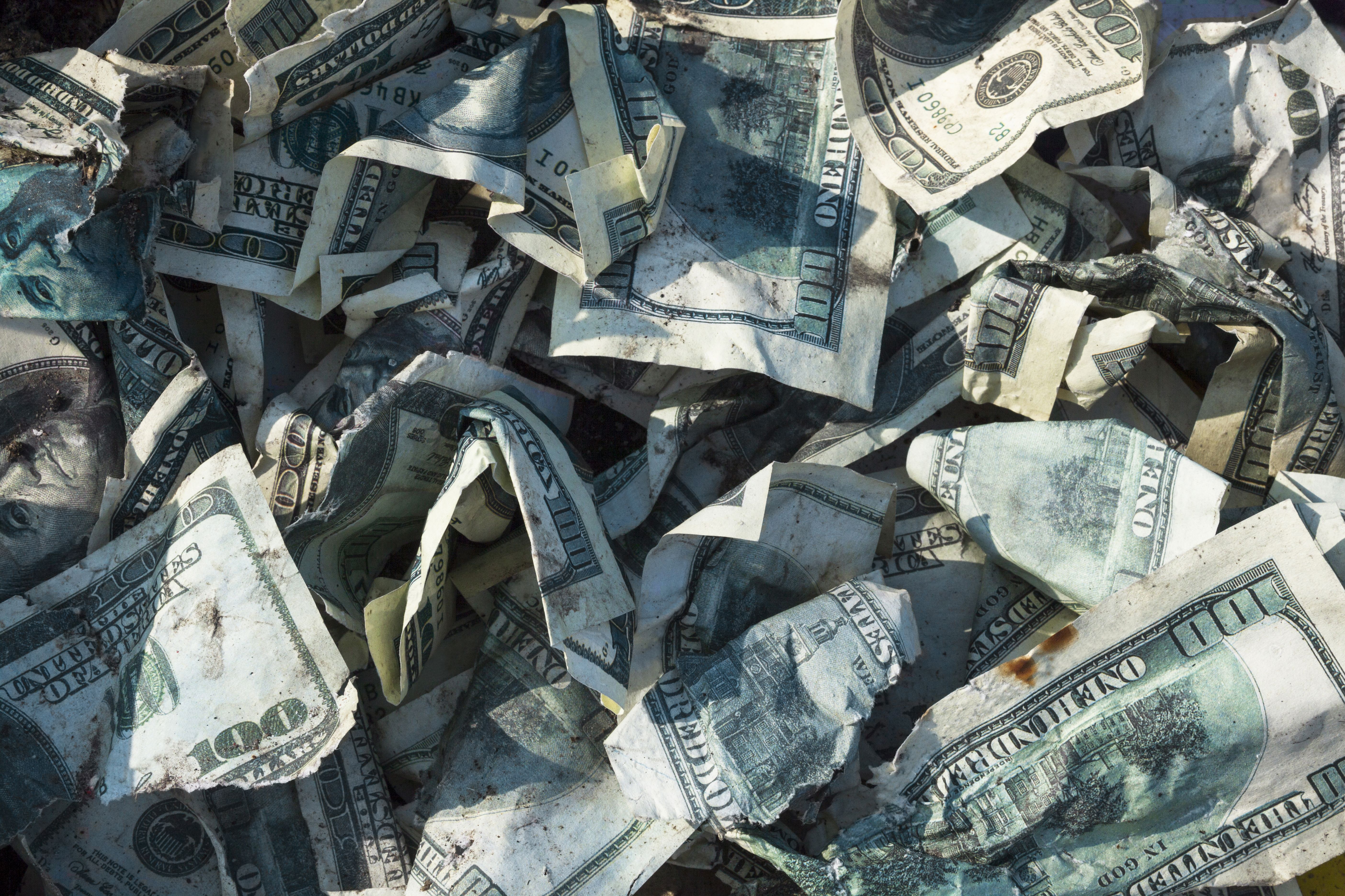 Crumpled up one hundred dollar bills. | Source: Shutterstock