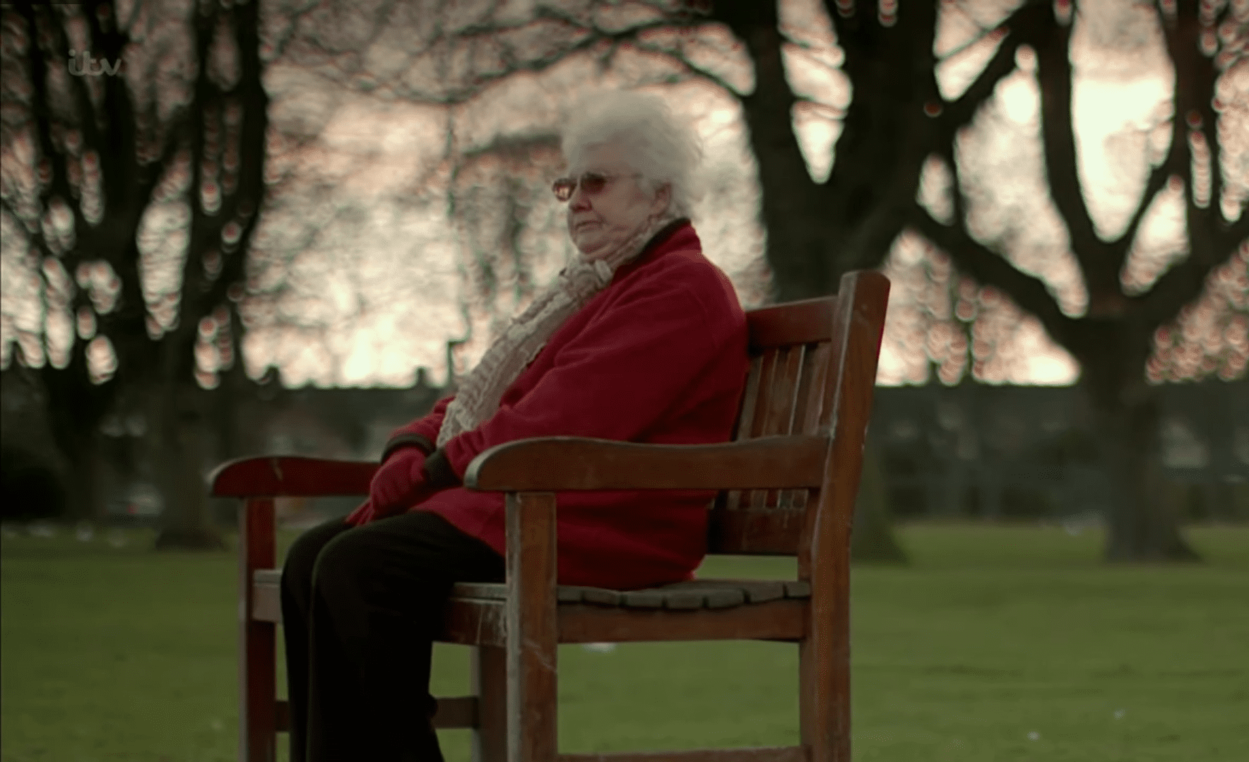 Pauline Wood sitting on a bench. | Source: youtube.com/ITV