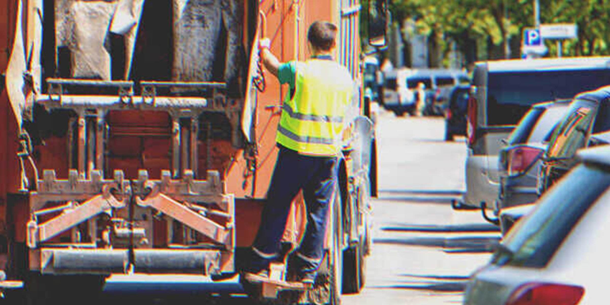 Garbage man on a garbage truck | Source: Shutterstock