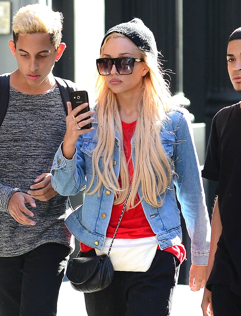 Wearing a red tee, denim jacket, and oversized sunglasses, Amanda Bynes is seen walking with friends through SoHo — keeping a low profile during a casual New York outing.
