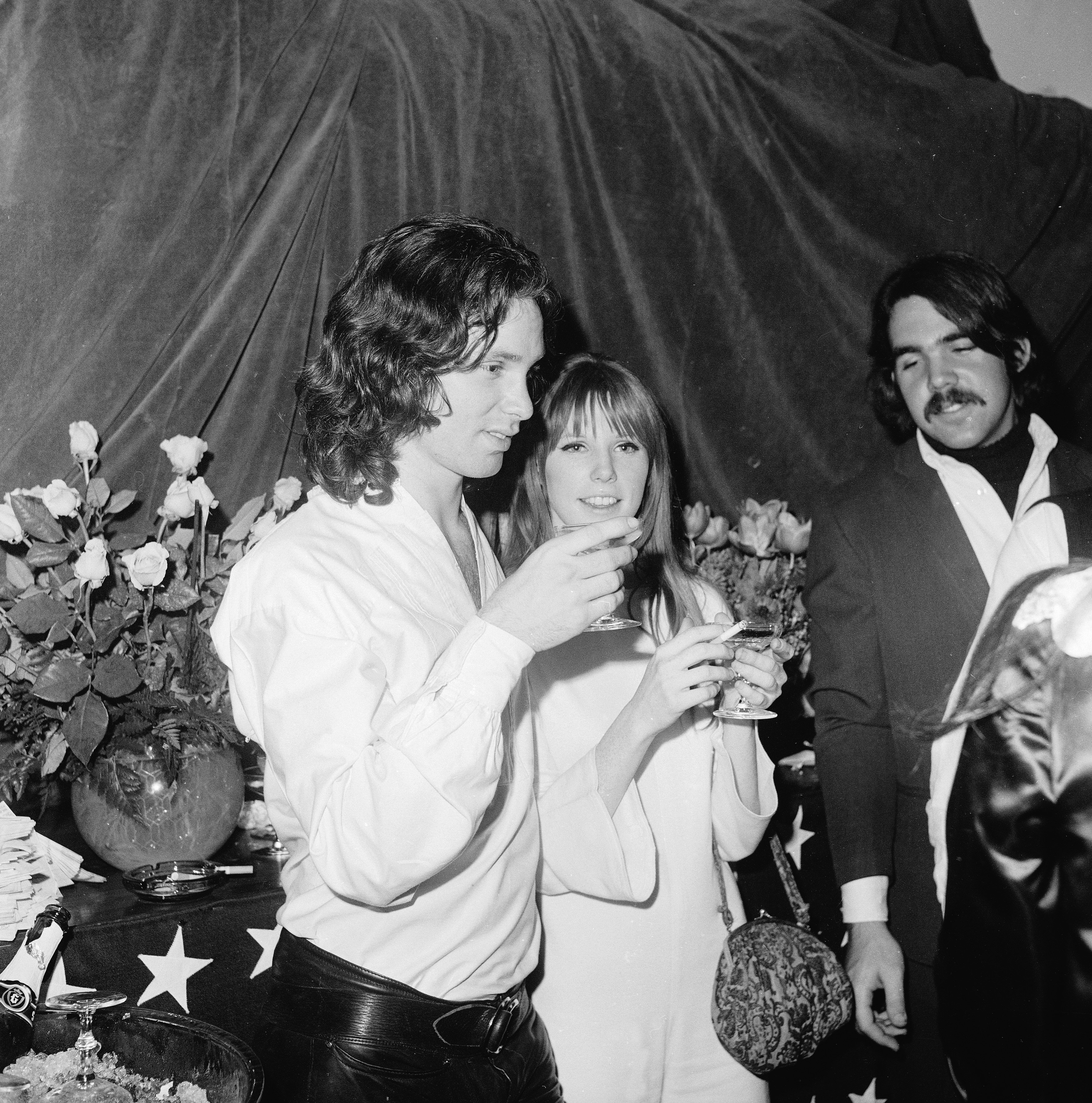 Jim Morrison  and Pamela Courson  have a drink at the opening of 'The Beard' at the Warner Playhouse, California, January 24, 1968.  Source: Getty Images
